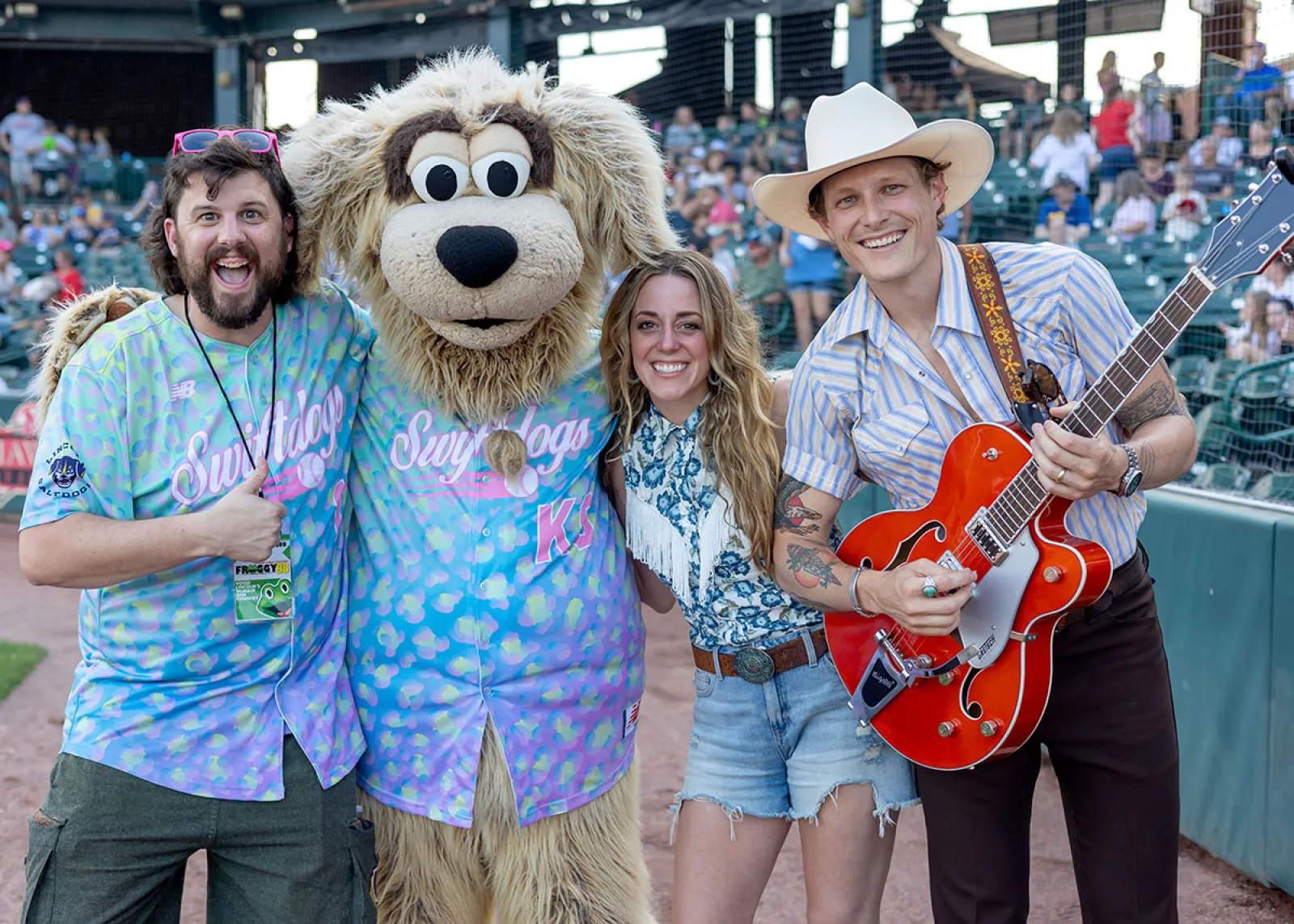 a group of people posing with a person in a garment
