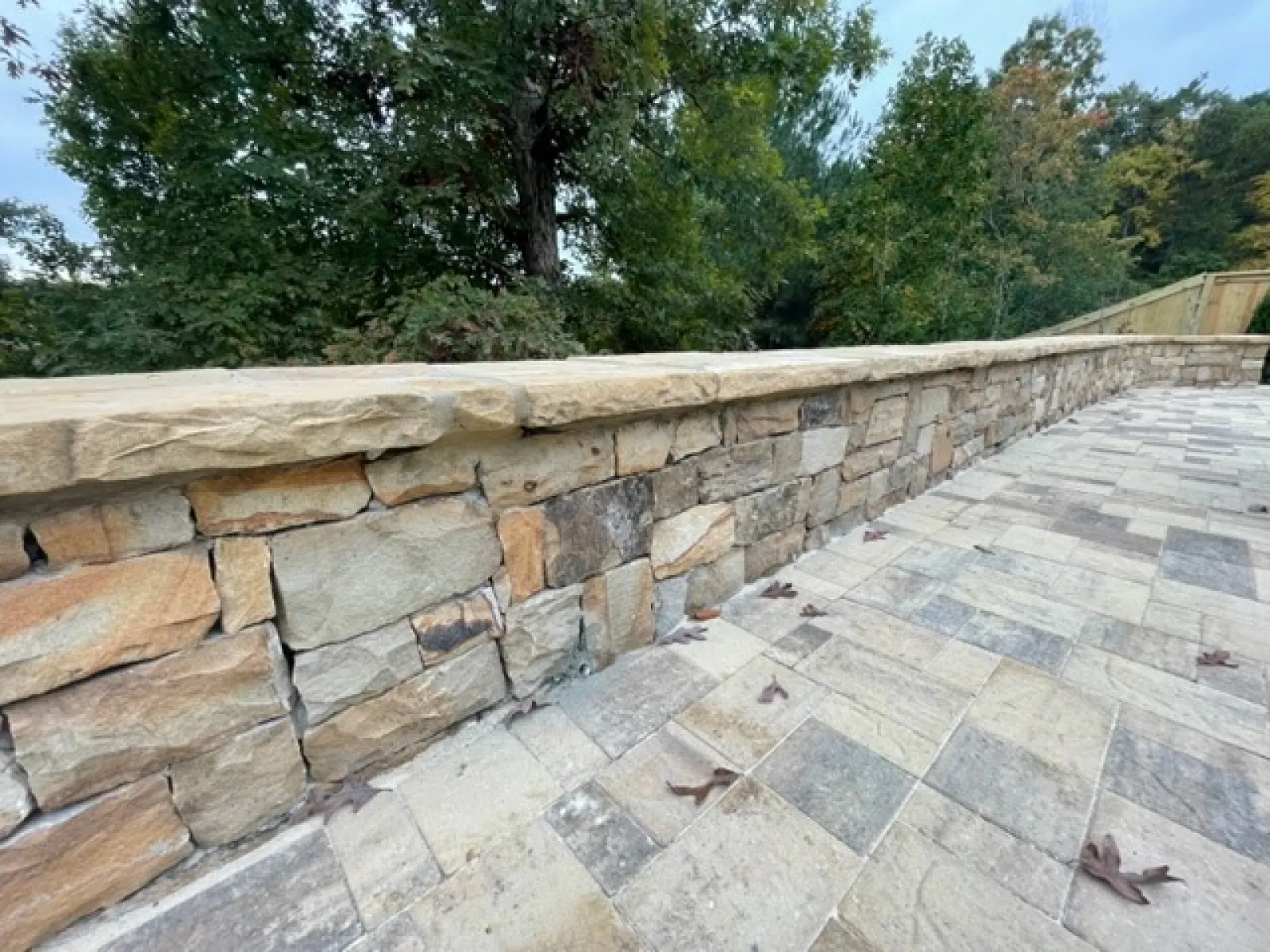 a stone wall with a stone walkway
