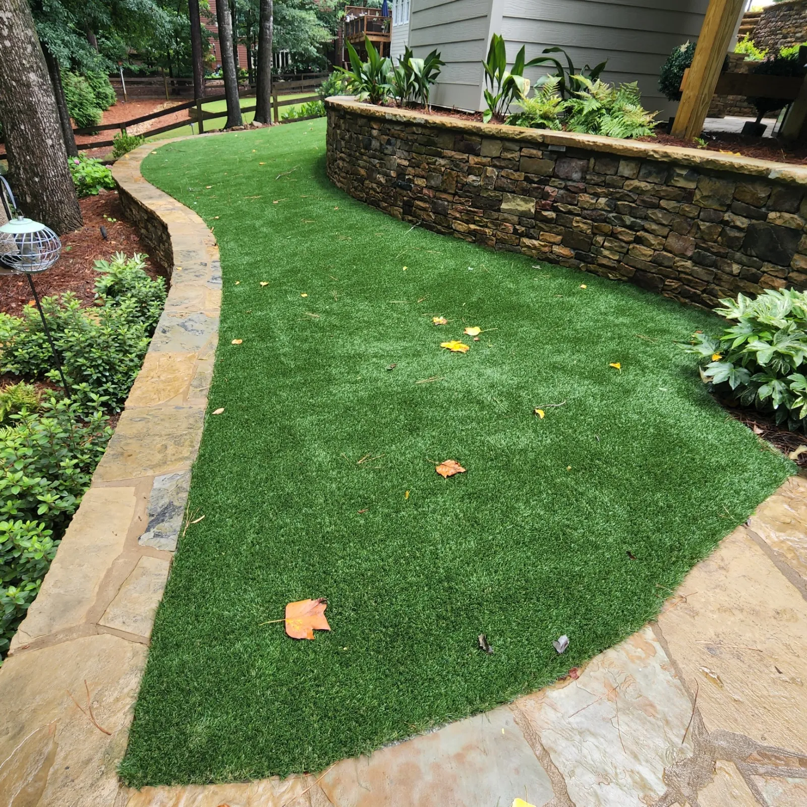 a small backyard with a stone path