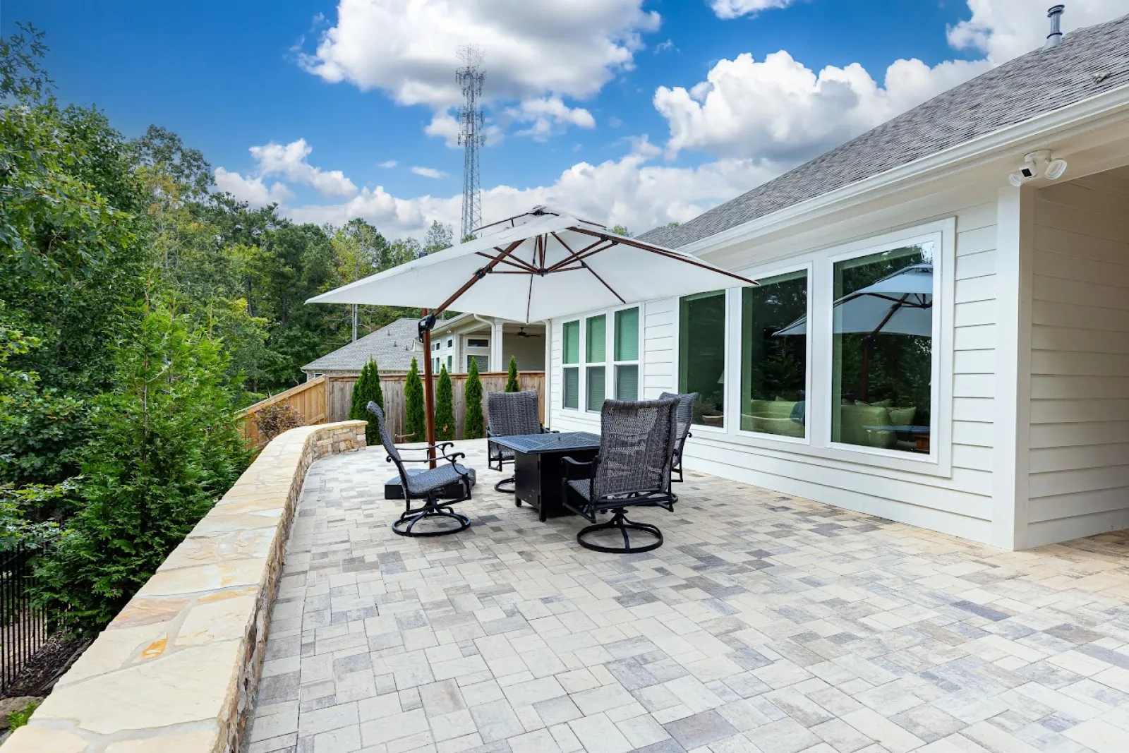 a patio with chairs and a table