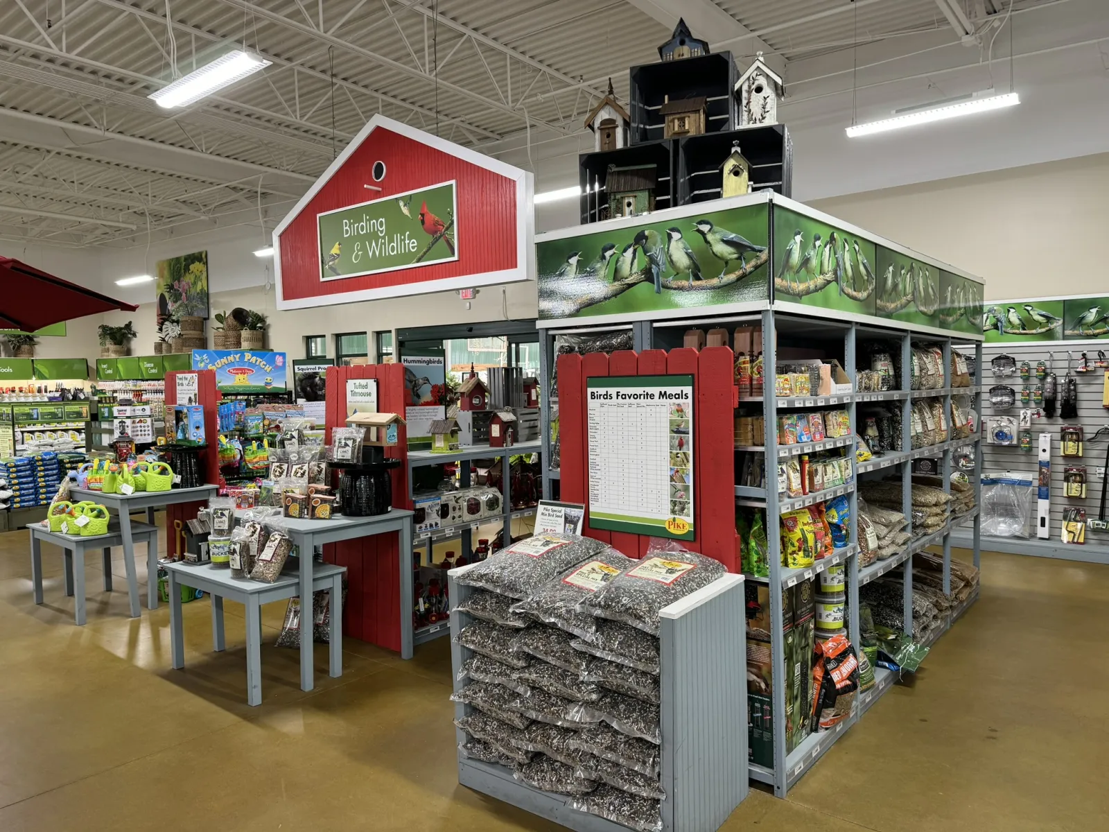 Store section for birding and wildlife supplies with birdseed, feeders, and birdhouses on display.