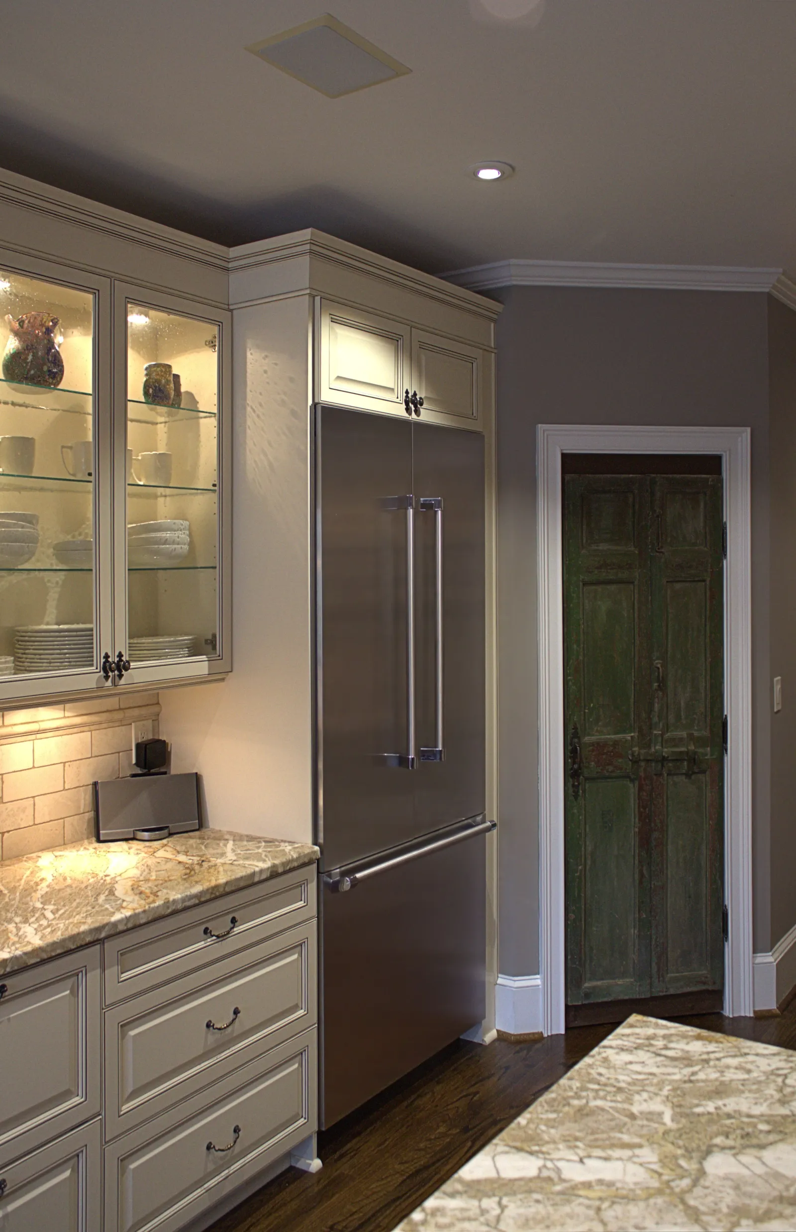 a kitchen with a stainless steel refrigerator