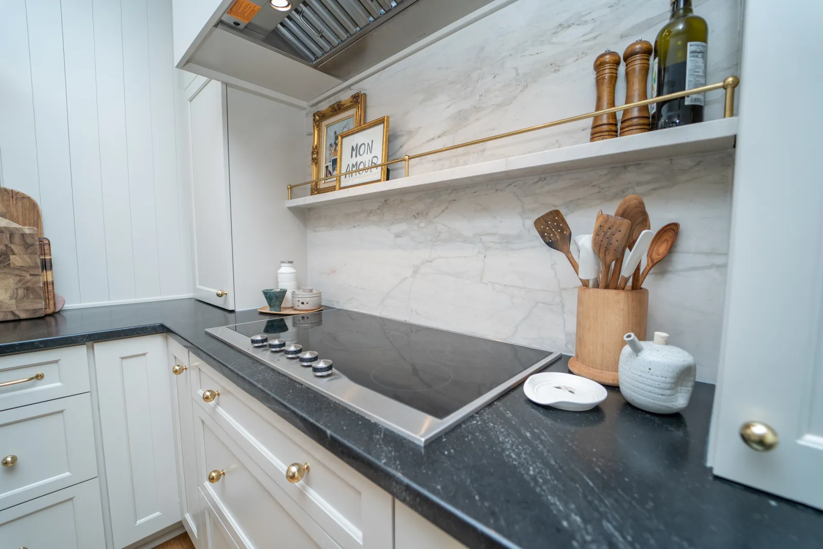 a kitchen with a stove and shelves