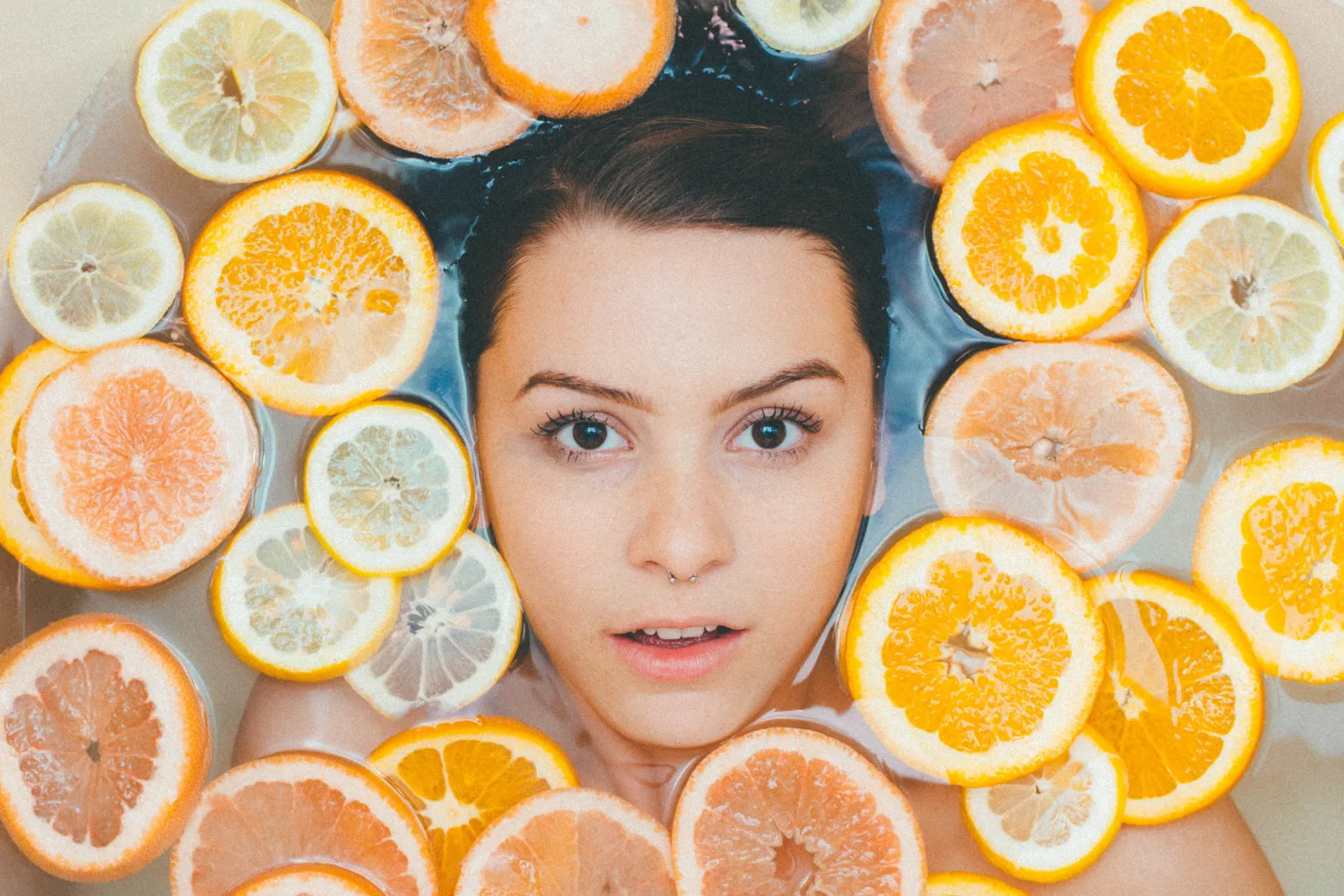 Vitamin C for Skincare woman face in citrus bath