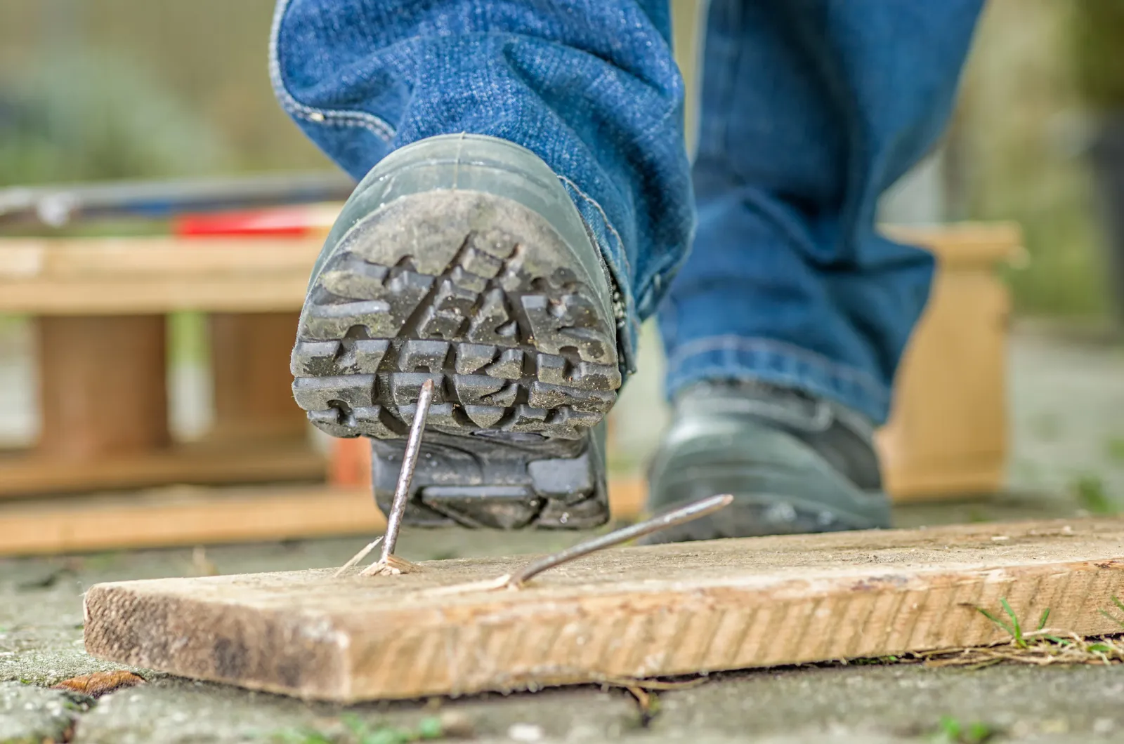 Work boot stepping on a nail