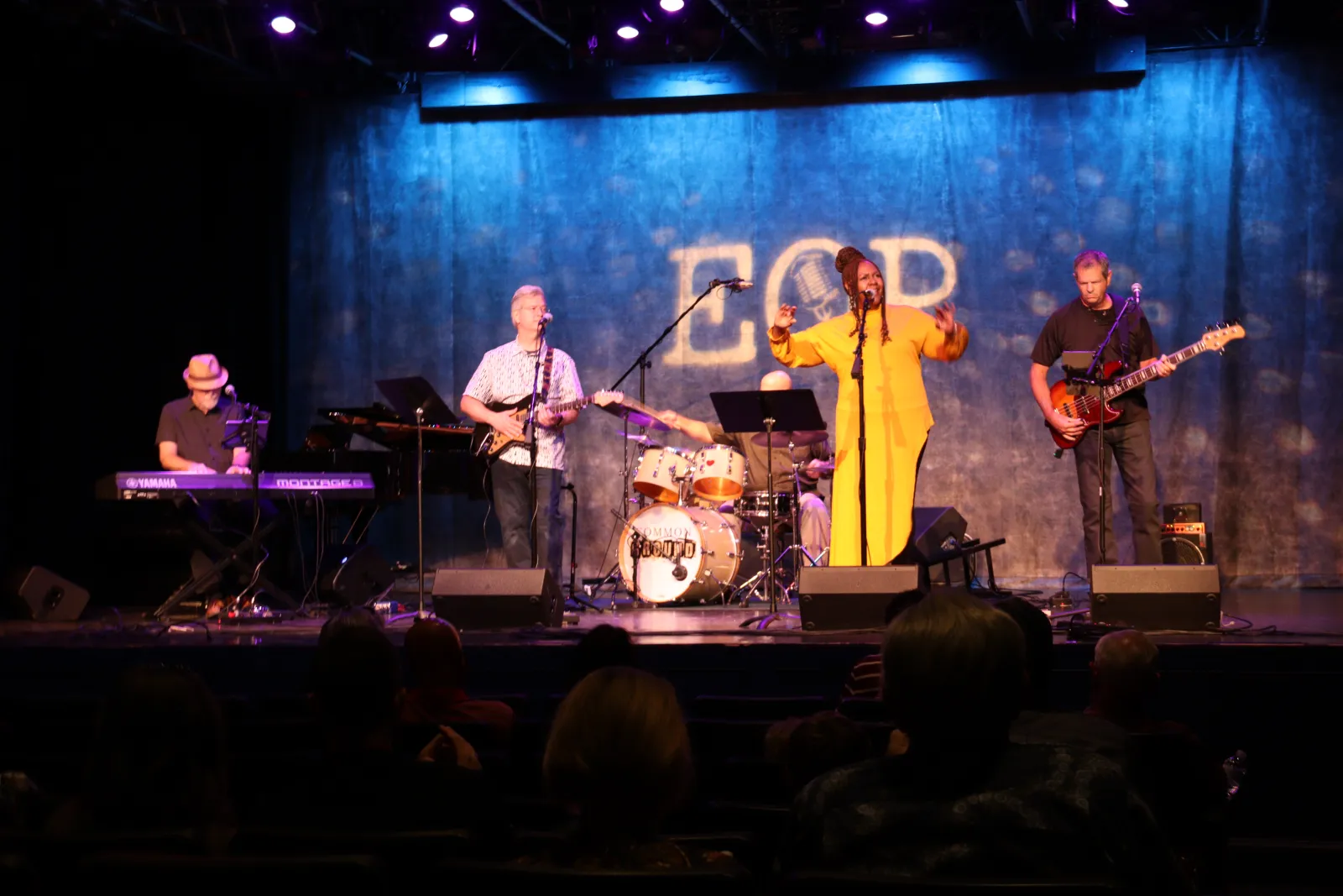 a group of people on a stage with musical instruments