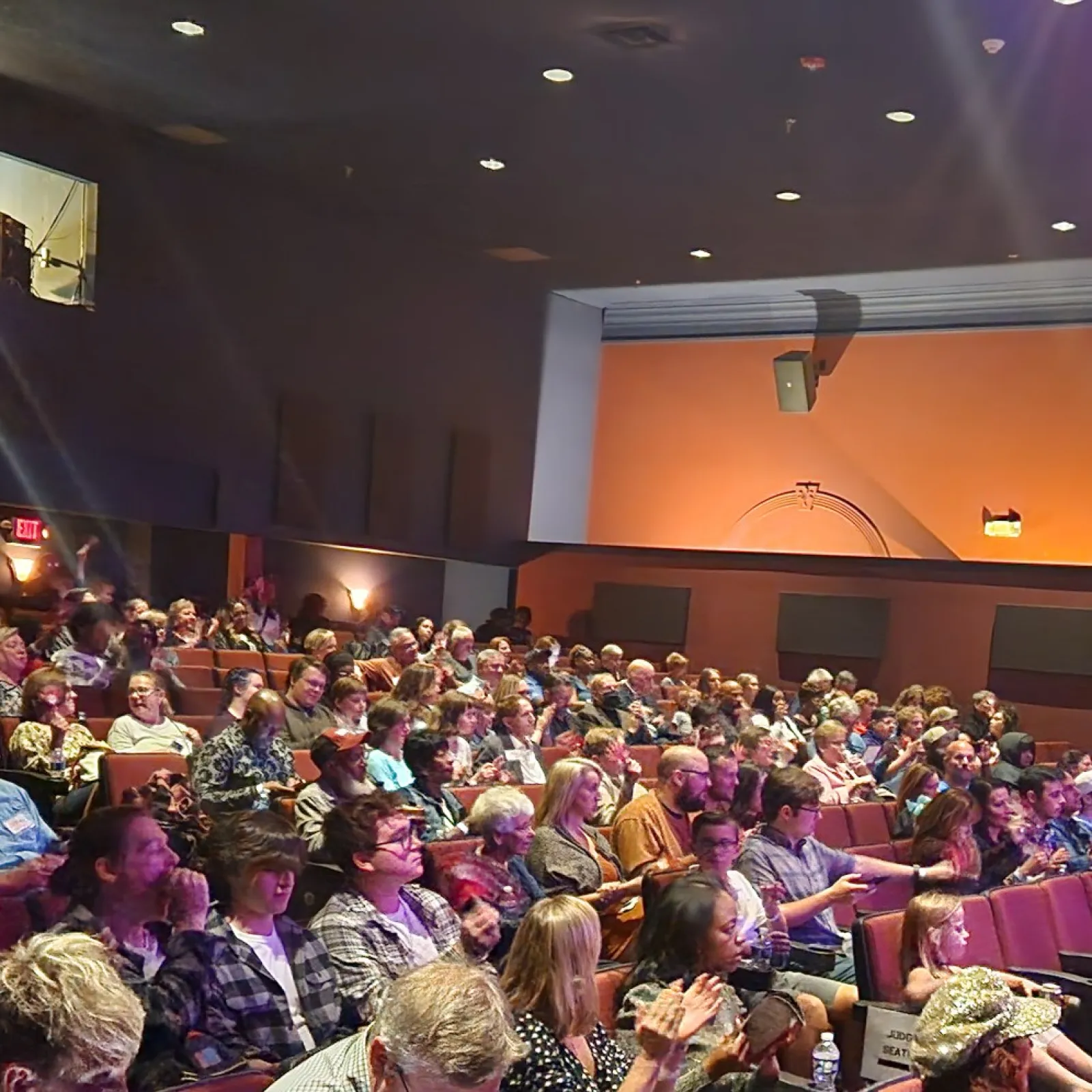 a large group of people sitting in a room