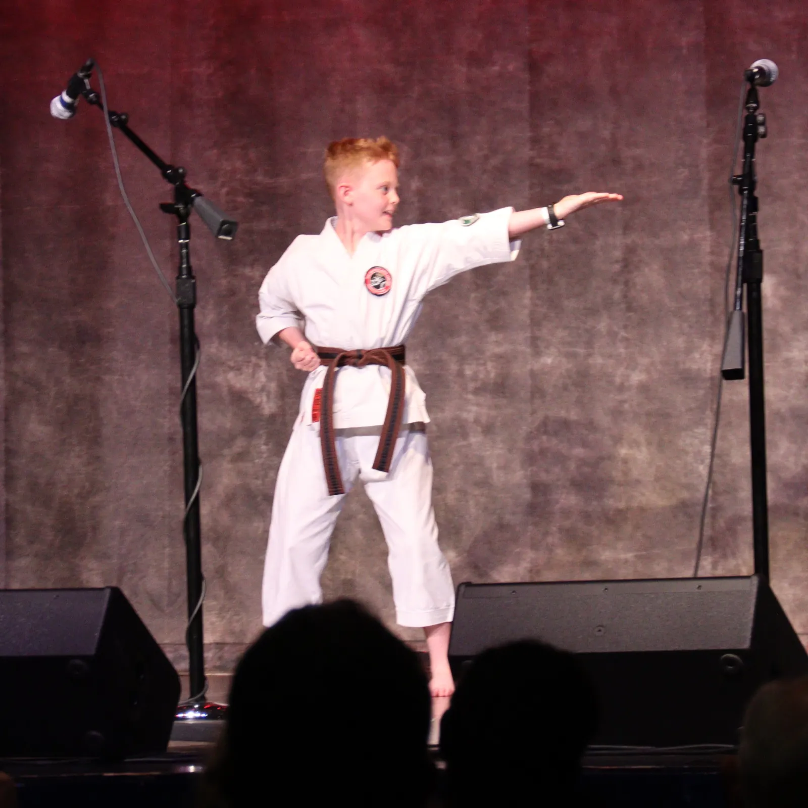a man in a karate uniform on a stage