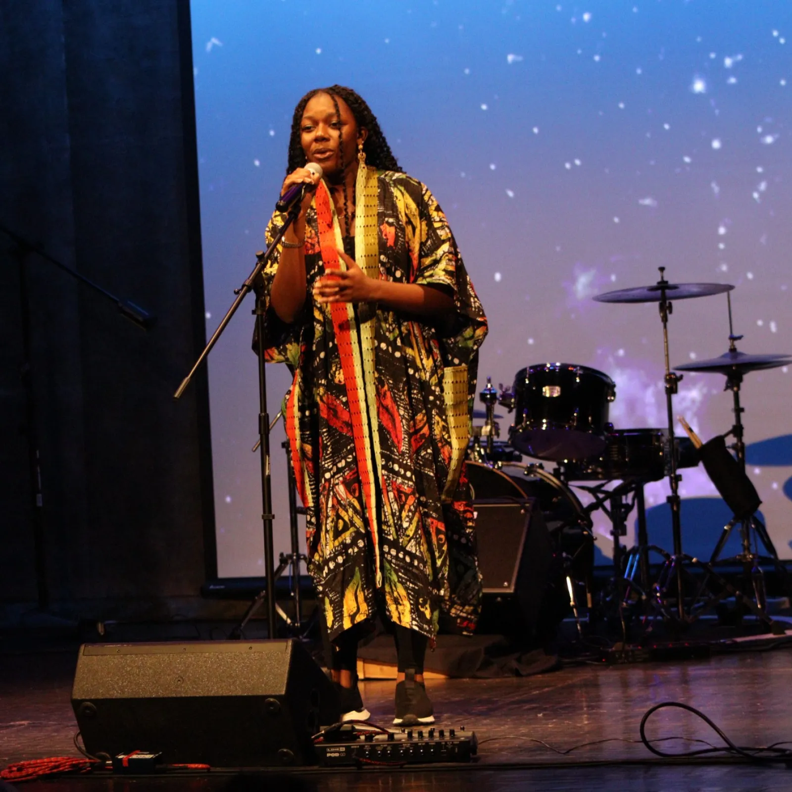 a person on stage with a microphone