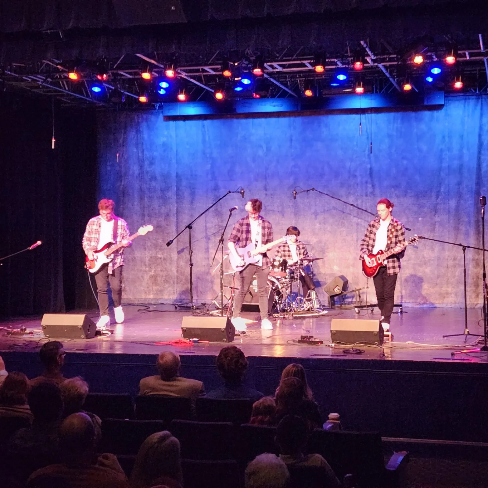 a group of people on a stage with musical instruments