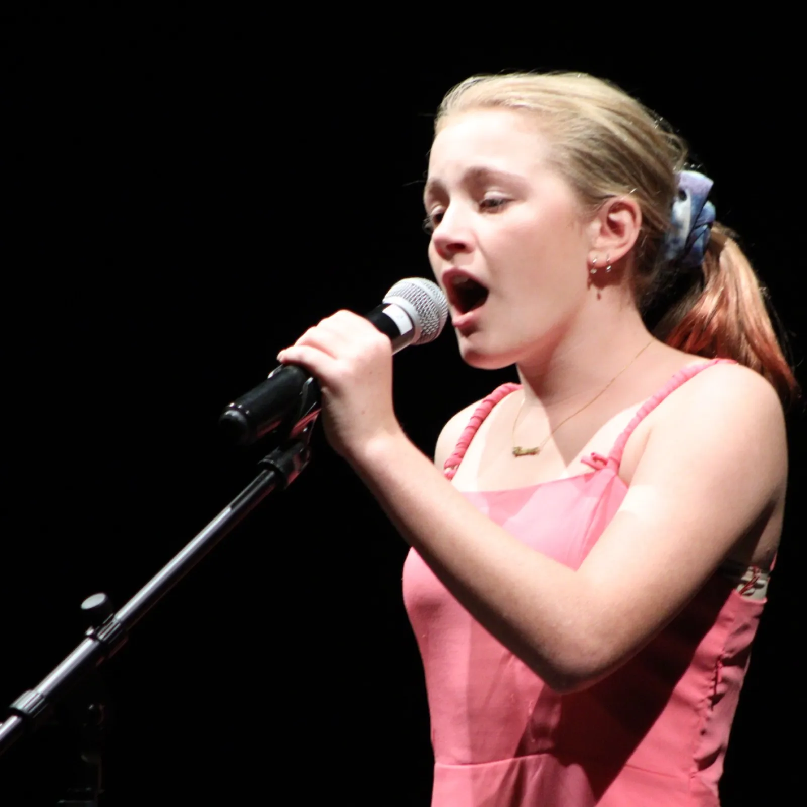 a woman singing into a microphone