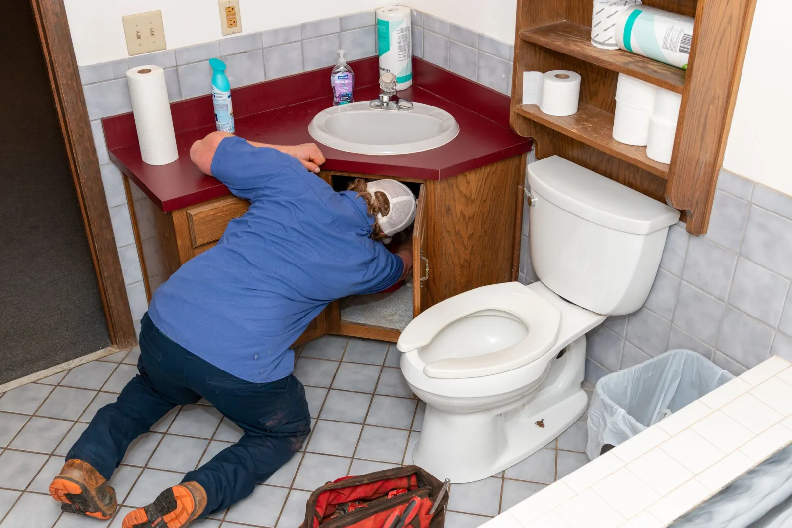 a plumber in marietta fixing a clogged toilet