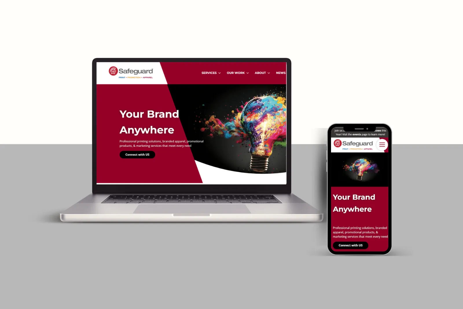 Laptop and smartphone displaying Safeguard branding and colorful lightbulb graphic with marketing services text