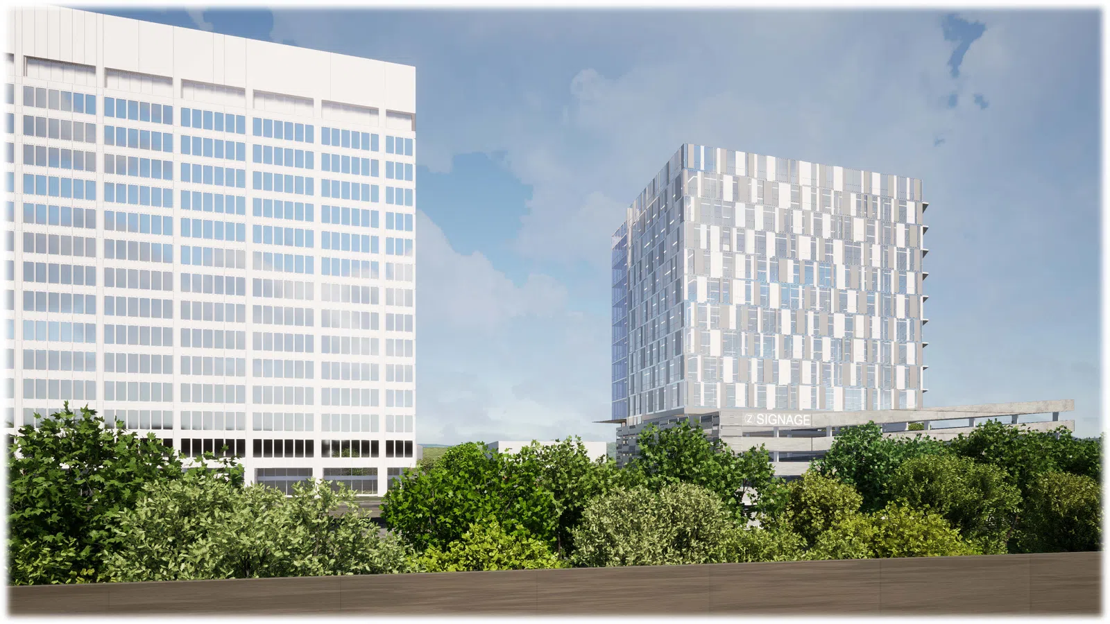 Modern white office buildings behind lush green trees under a partly cloudy blue sky