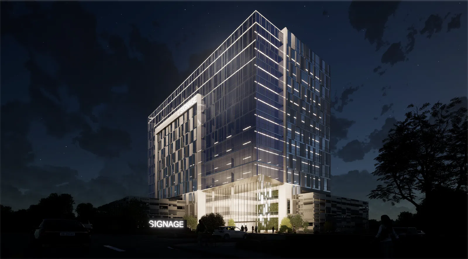 Modern glass office building illuminated at night with signage and surrounding trees under a starry sky.