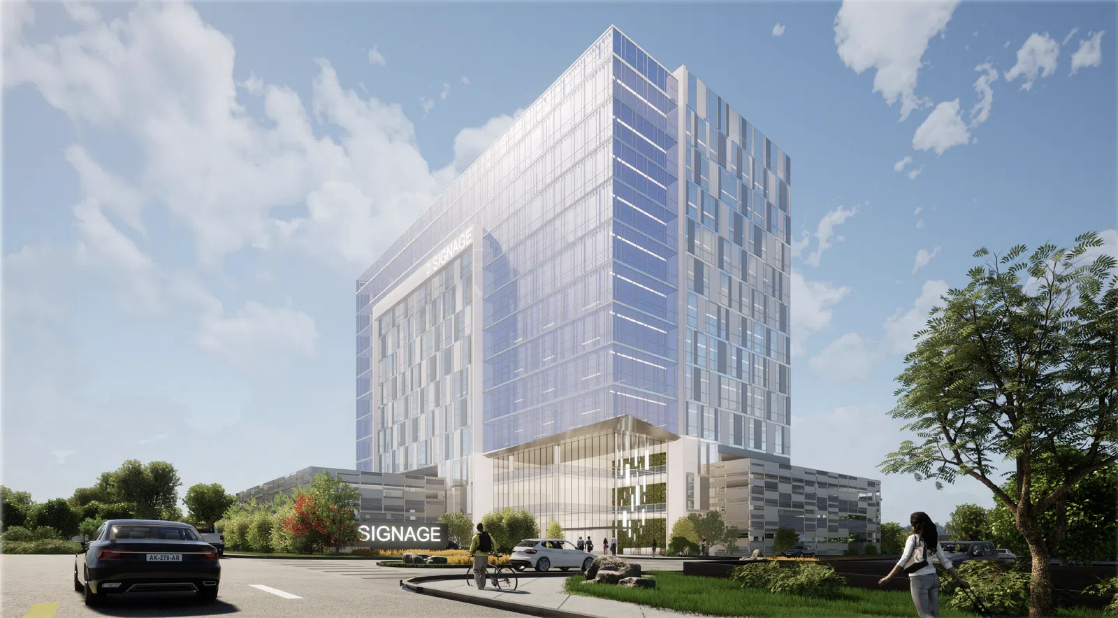 Modern glass office building with reflective windows under blue sky, surrounded by greenery and cars.