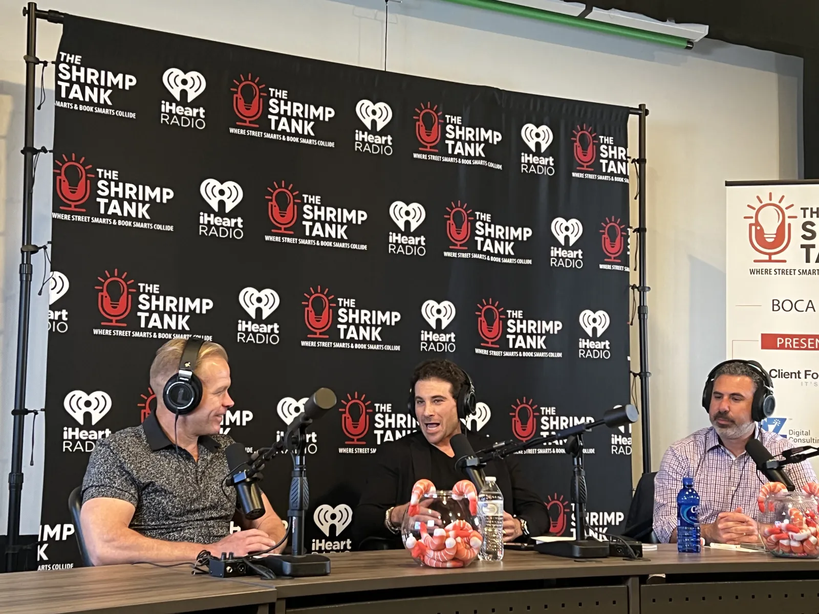 a group of men sitting at a table with microphones