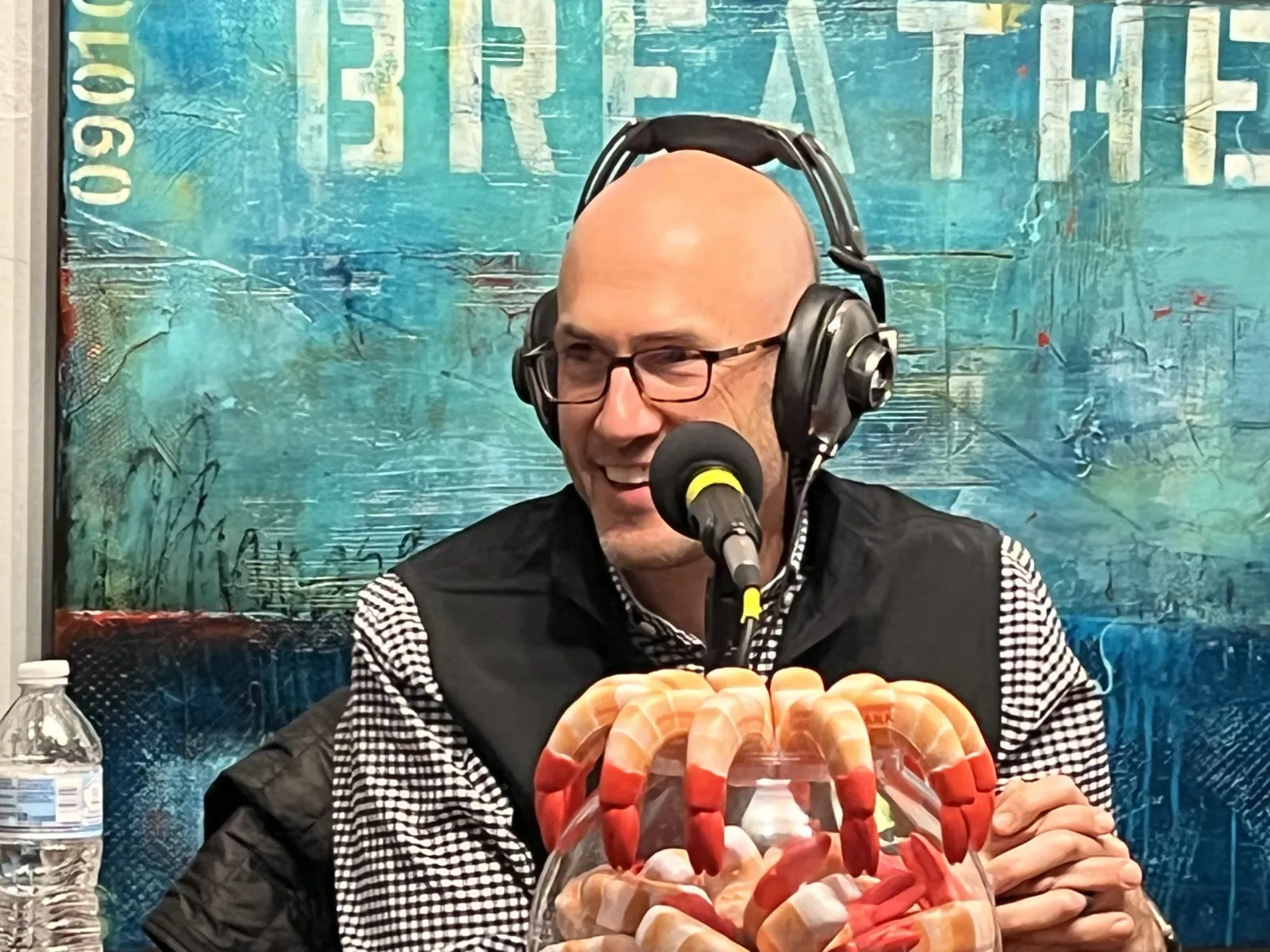 a person wearing headphones and holding a basket of food