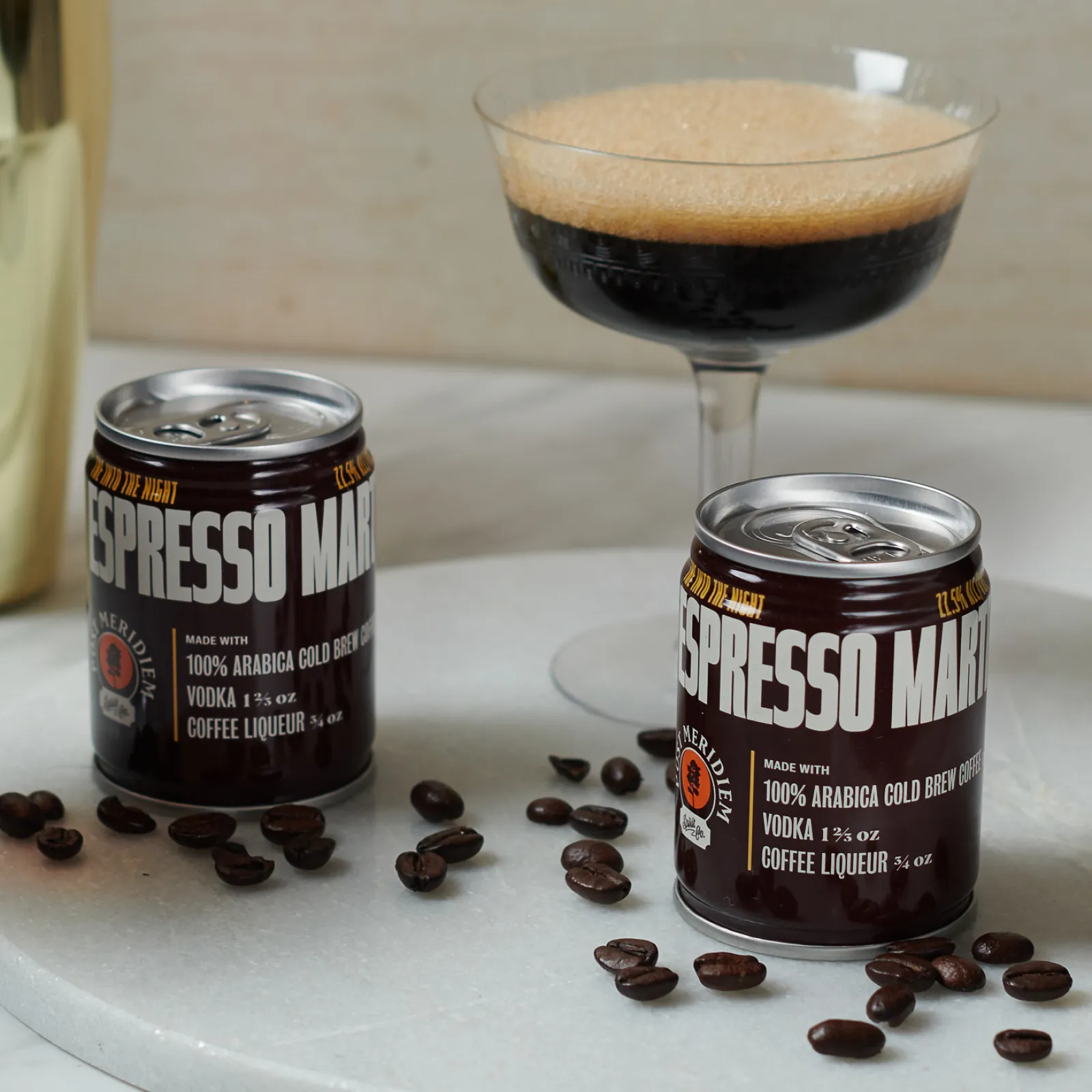 a group of coffee beans next to a glass of coffee