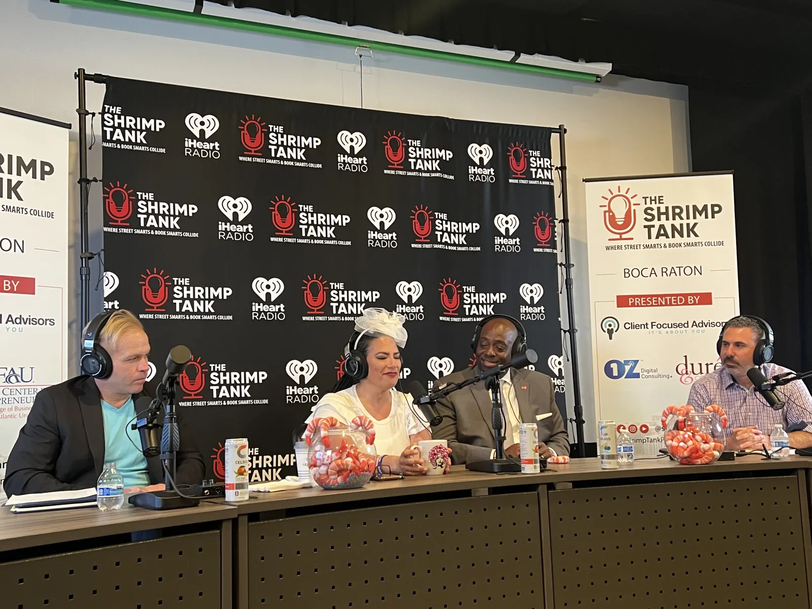 a group of people sitting at a table with microphones