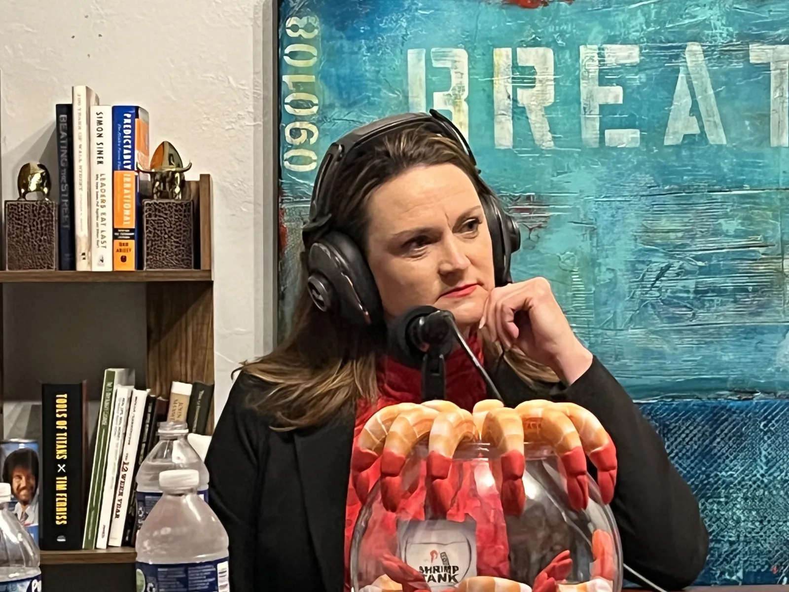 a woman wearing headphones and holding a bag of candy
