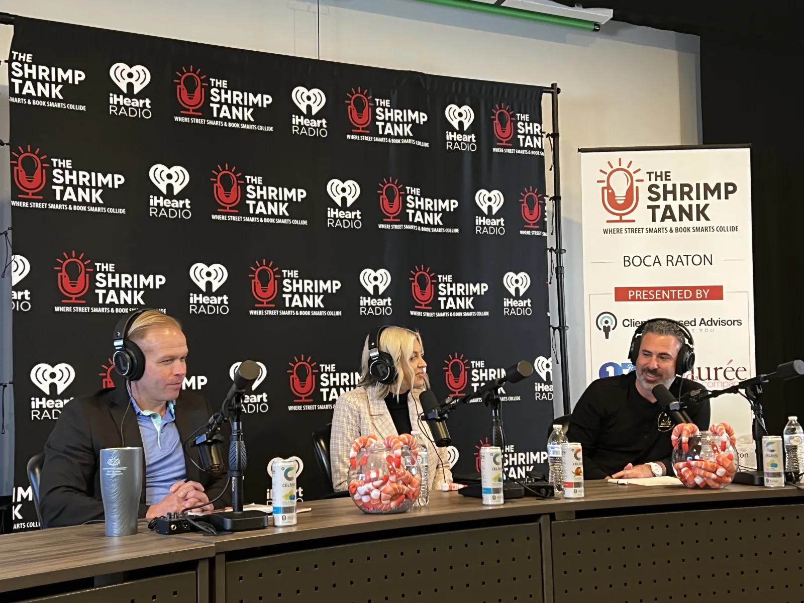 a group of people sitting at a table with microphones