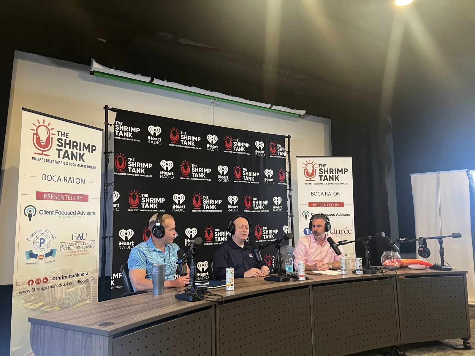 a group of people sitting at a table with microphones