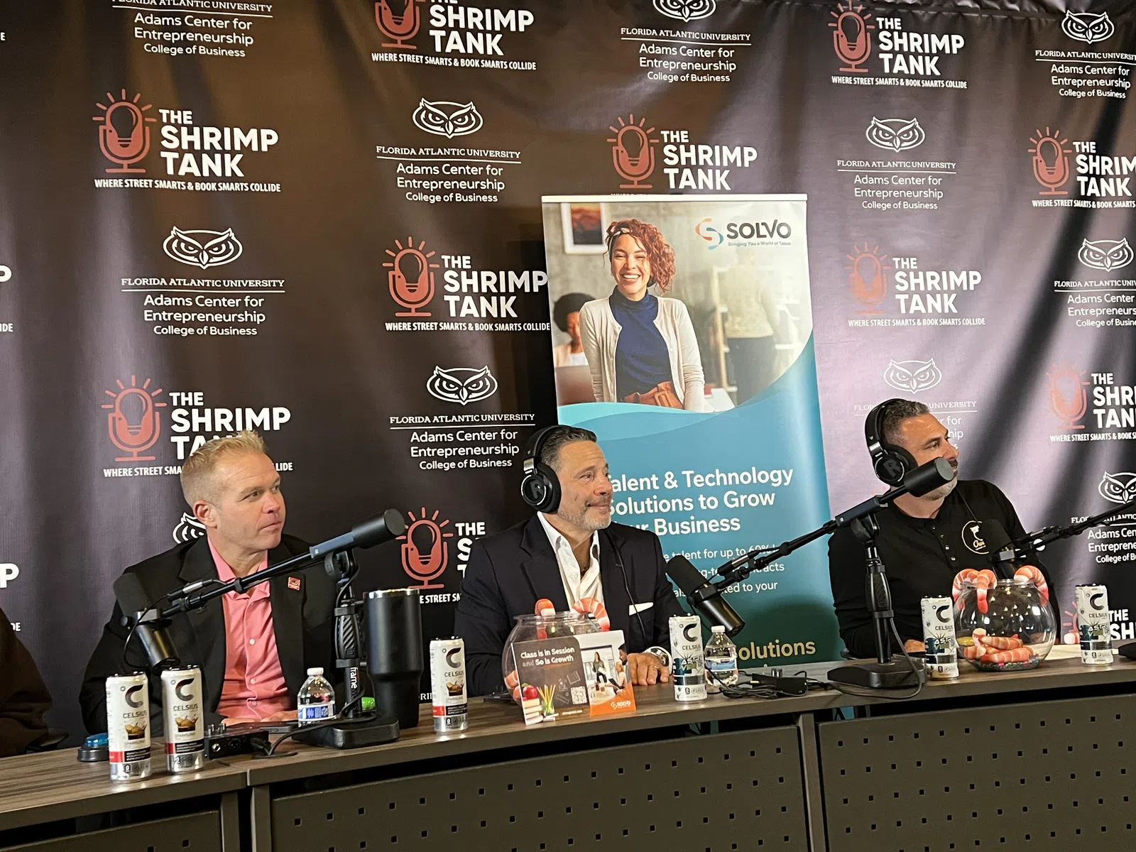 Panel of three men speaking into microphones at The Shrimp Tank event hosted by Florida Atlantic University