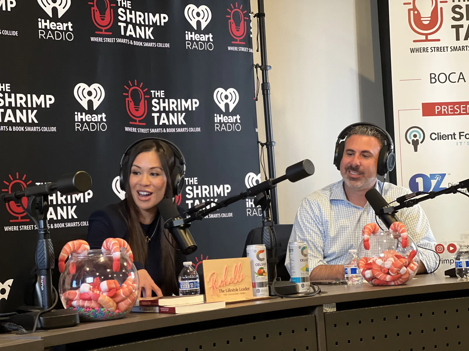 a man and woman at a table with microphones