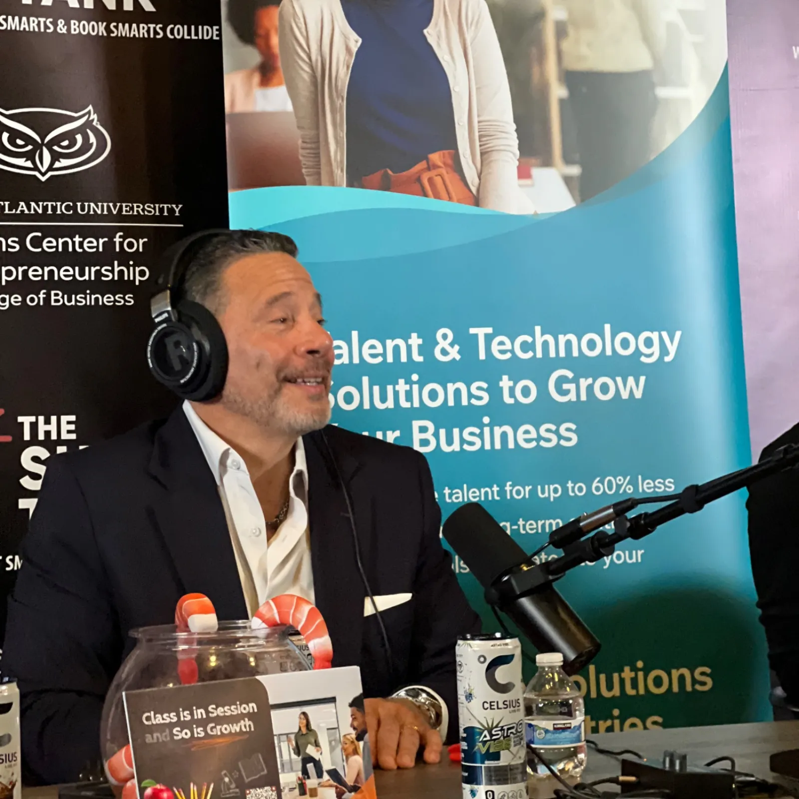 Man in headphones speaking into a microphone at a podcast setup with Solvo banner about talent and technology solutions.