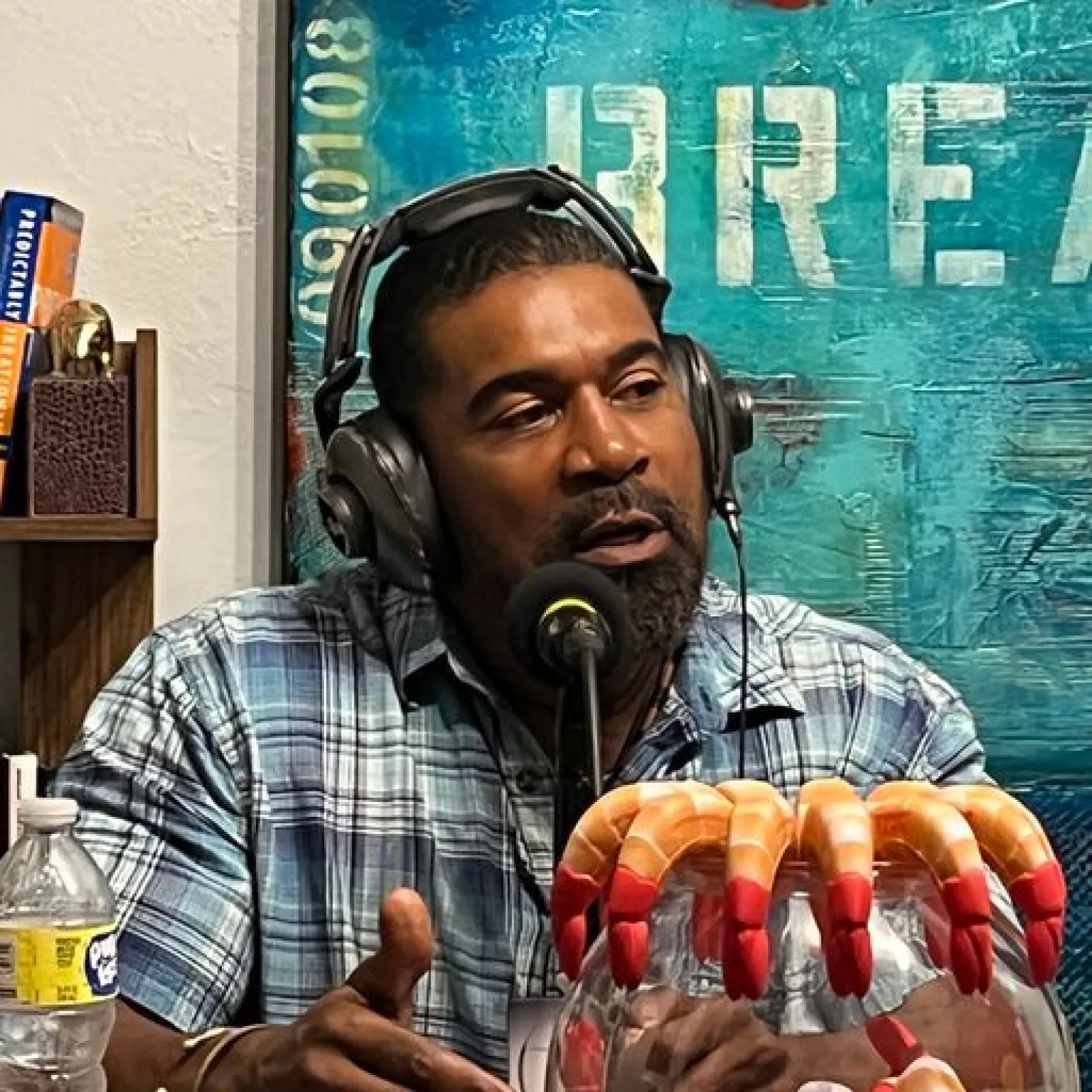 a person wearing headphones and holding a box of hot dogs