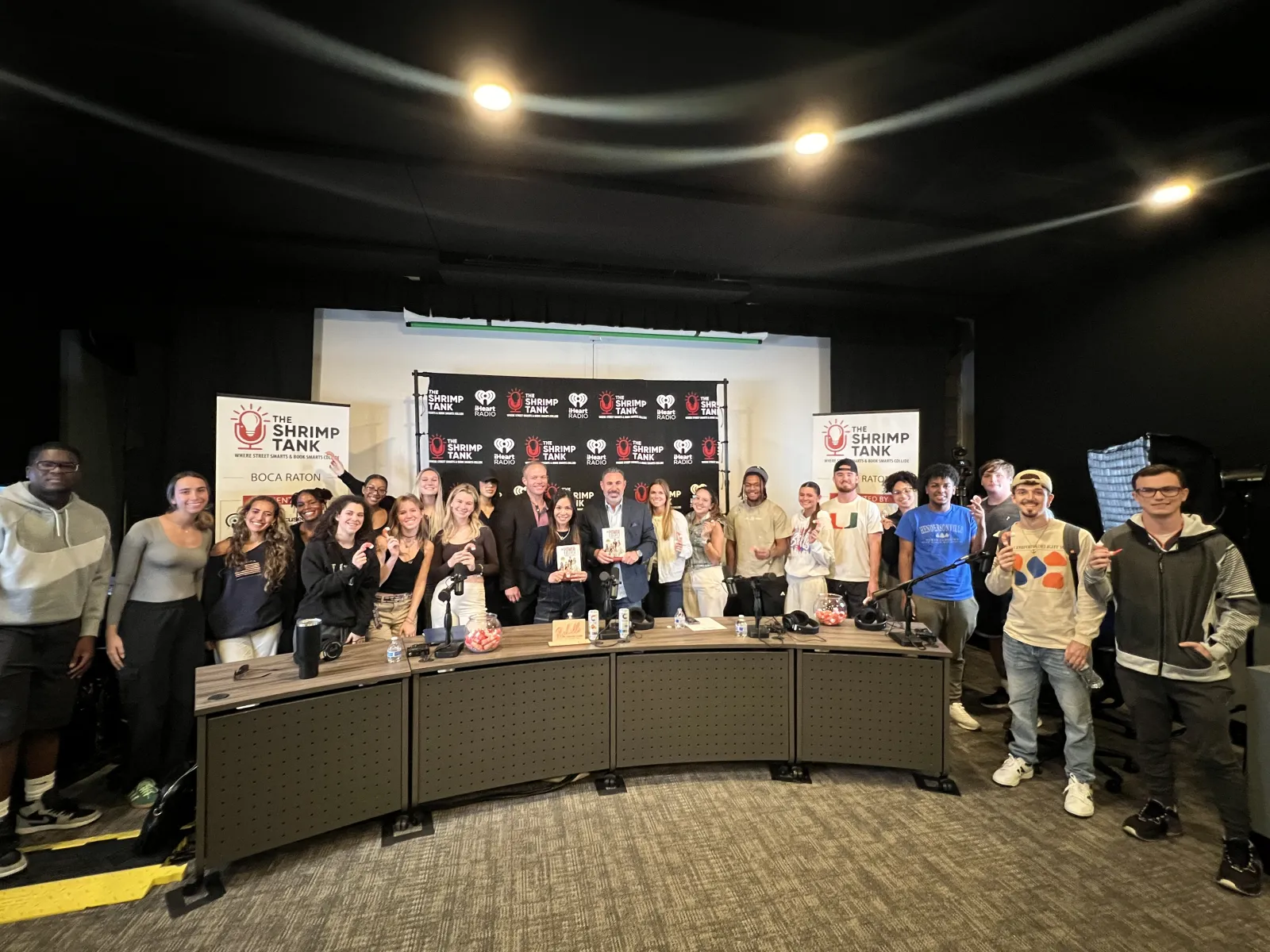 a group of people standing in front of a sign