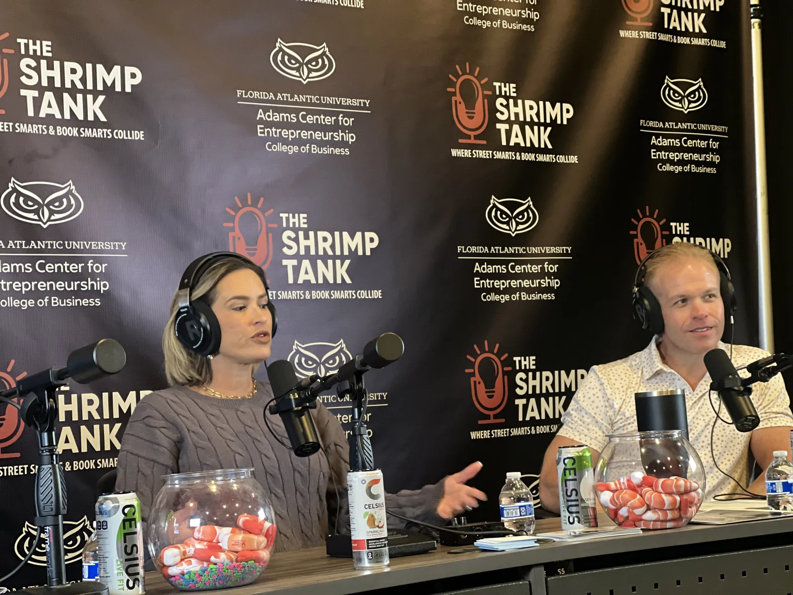 women sitting at a table with microphones and drinks