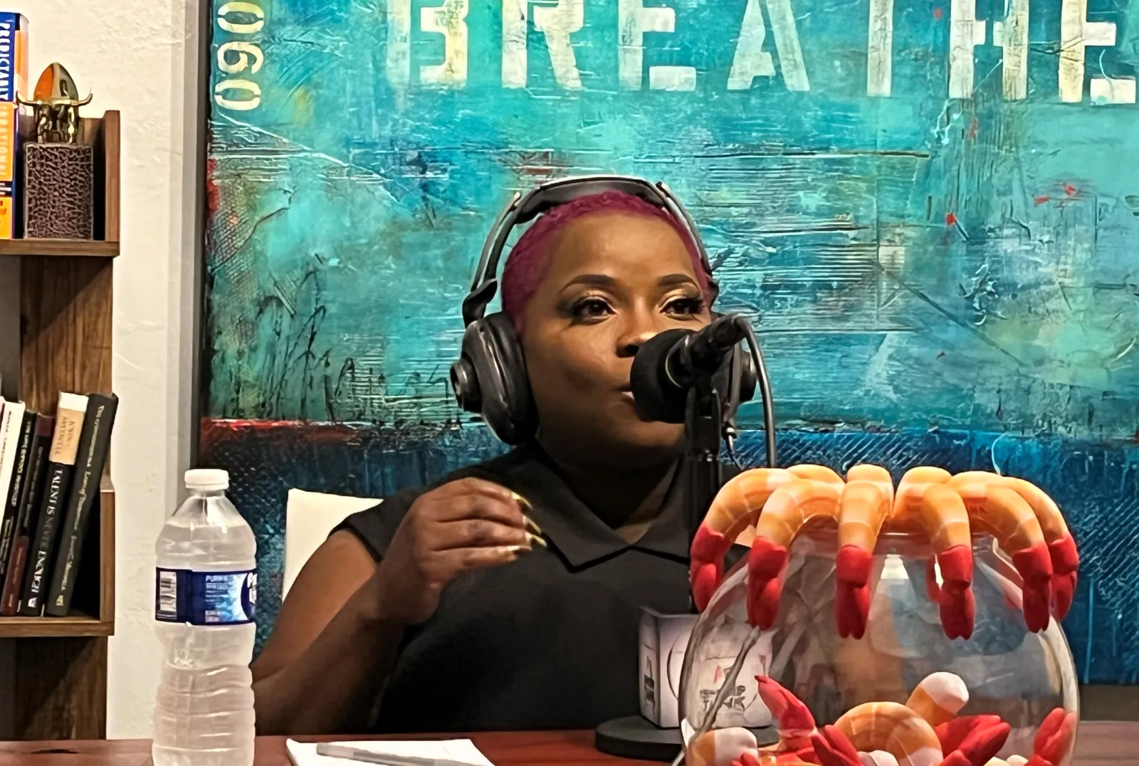 a girl wearing headphones and sitting at a table with food