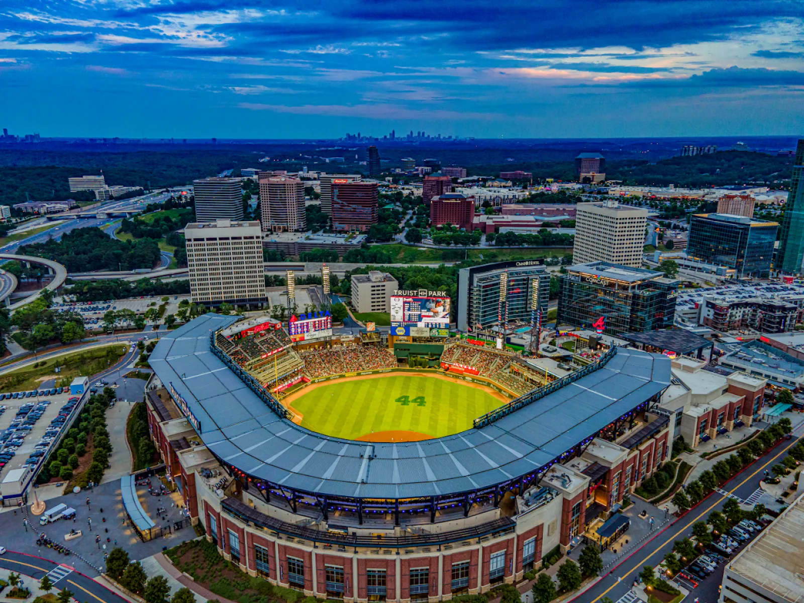 Aerial view of Truist Park baseball stadium with cityscape and cloudy sky at dusk