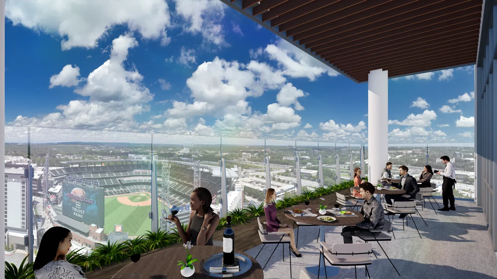 People dining on a rooftop terrace overlooking a baseball stadium and city under a blue sky with clouds.