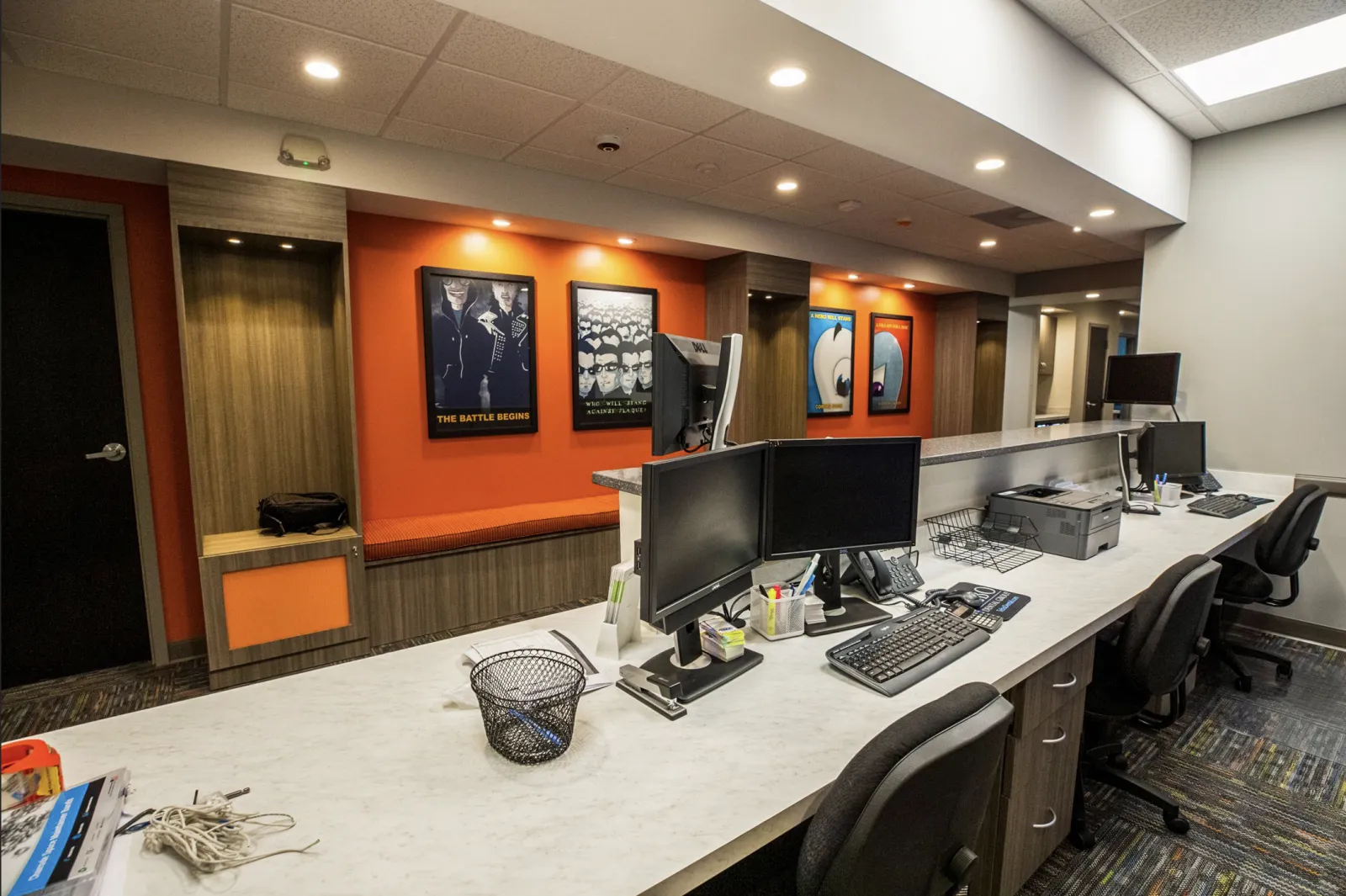 a room with a desk and computers