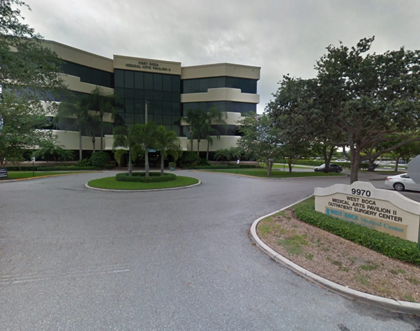 West Boca Medical Arts Pavilion II outpatient surgery center building with signage and surrounding trees.