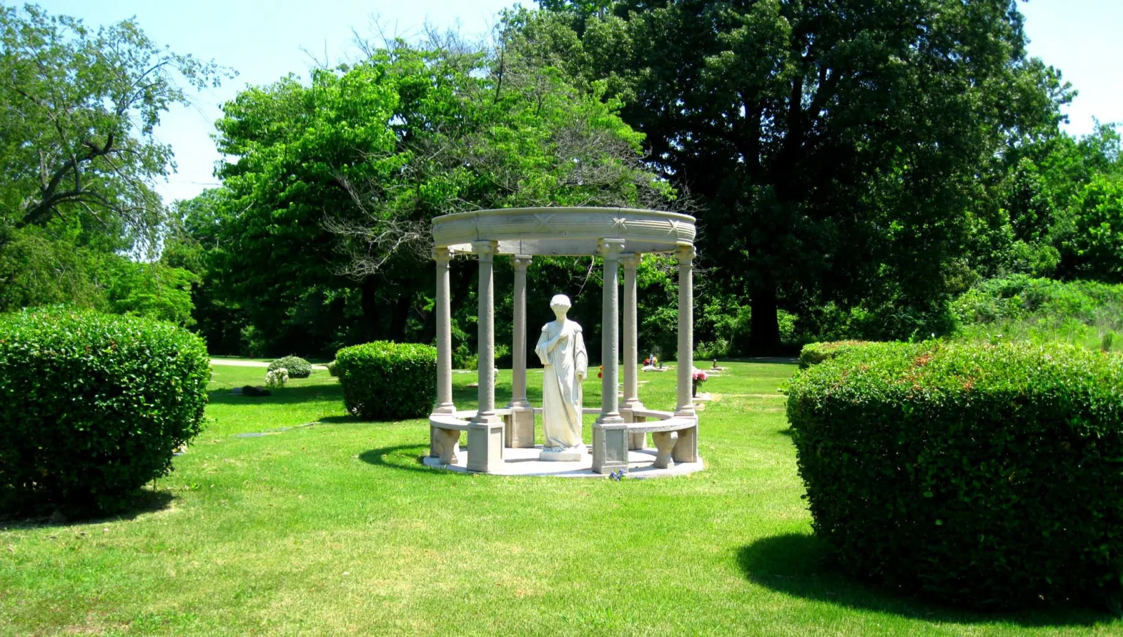 a statue of a person in a garden