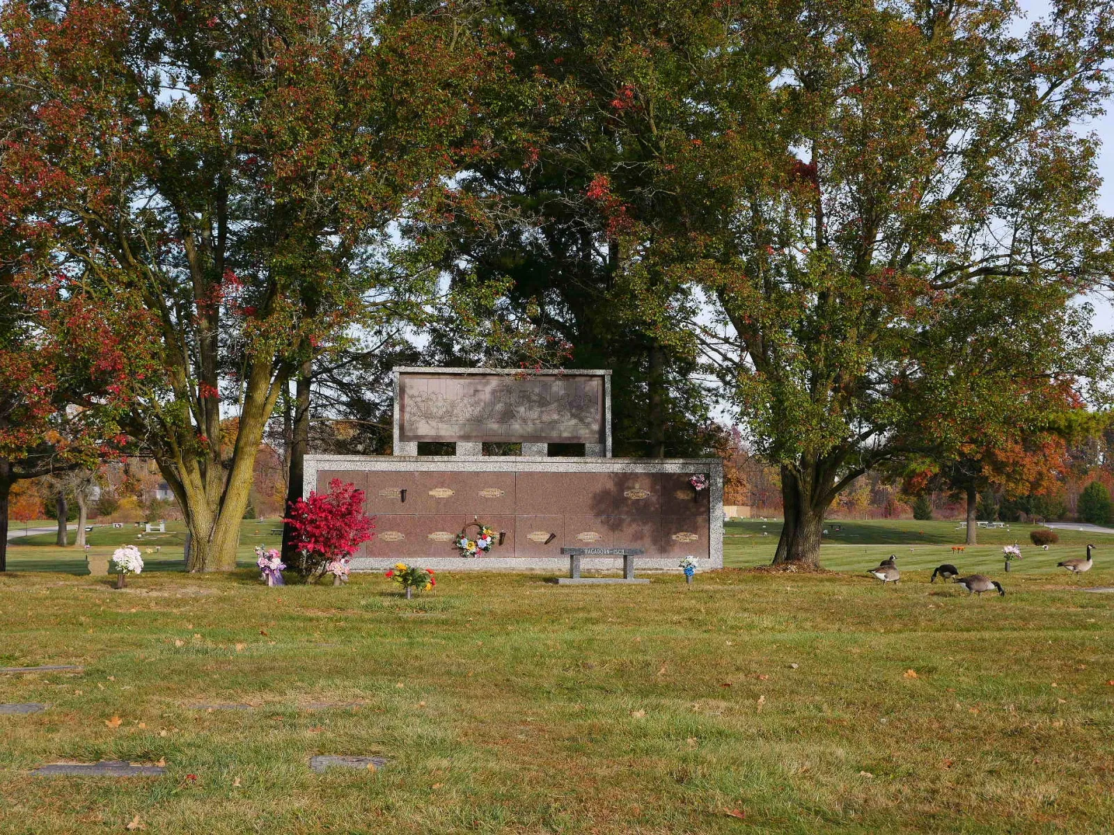 a group of people sitting on the grass by a building