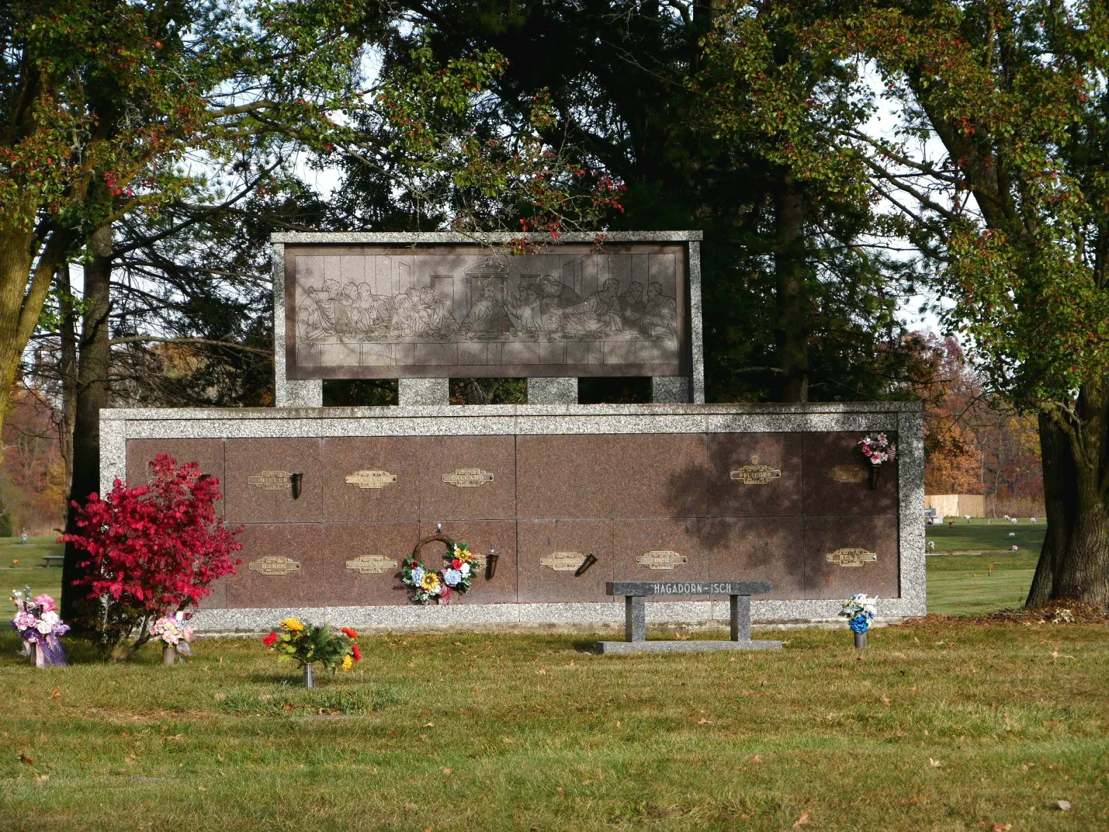 a stone building with a bench and a child walking by it