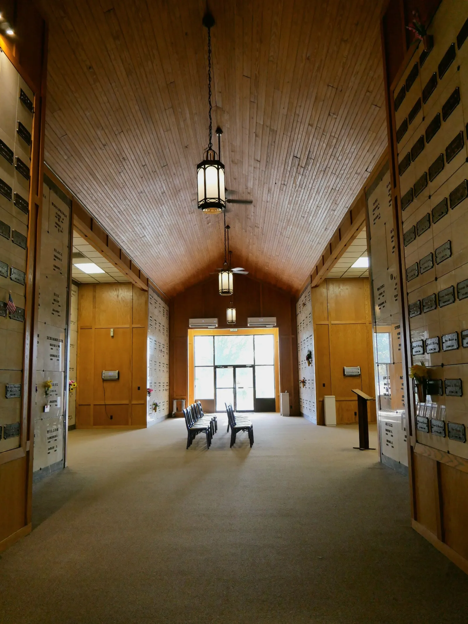 a hallway with a few chairs and a light fixture