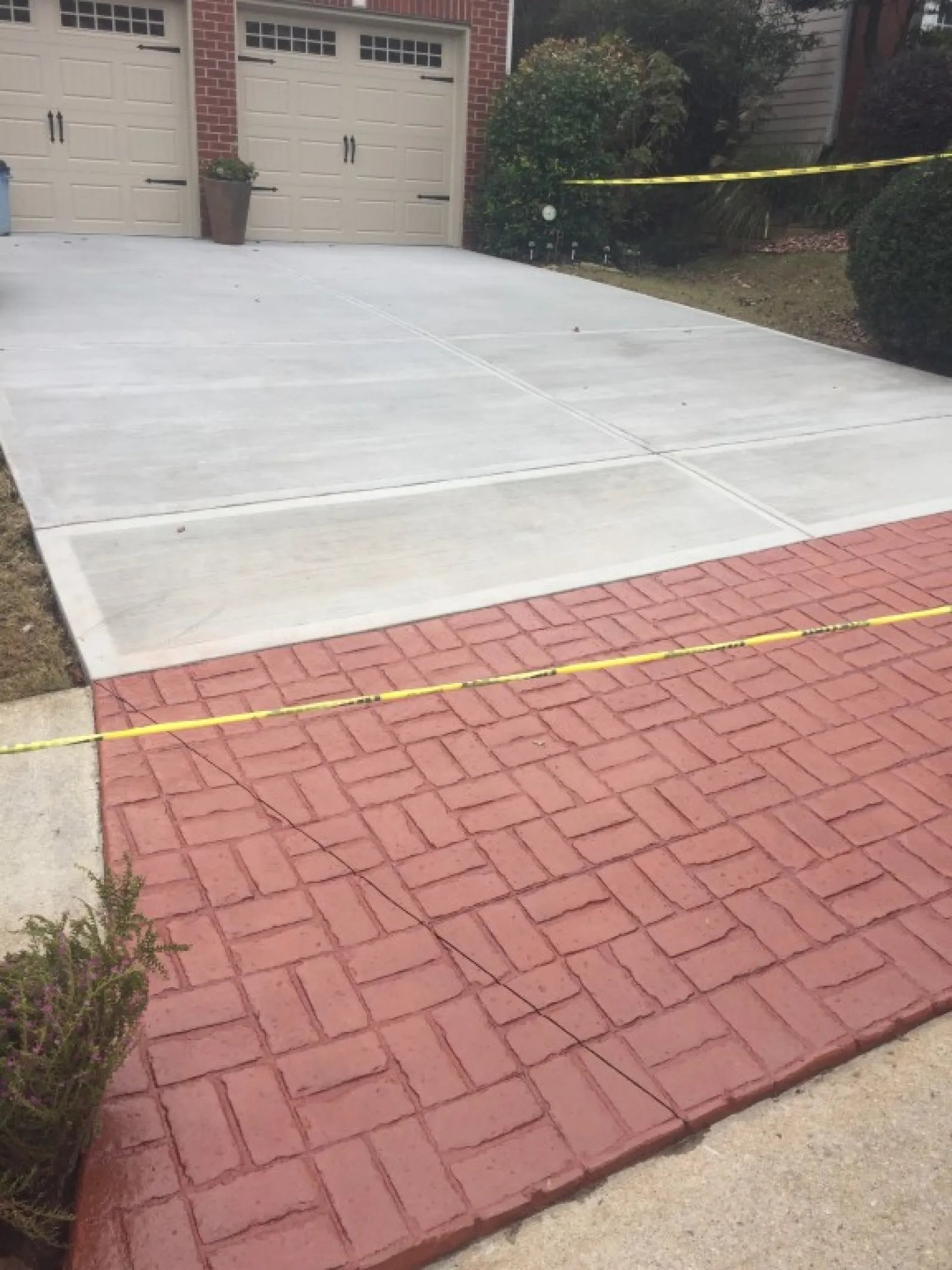 a brick driveway with a brick walkway