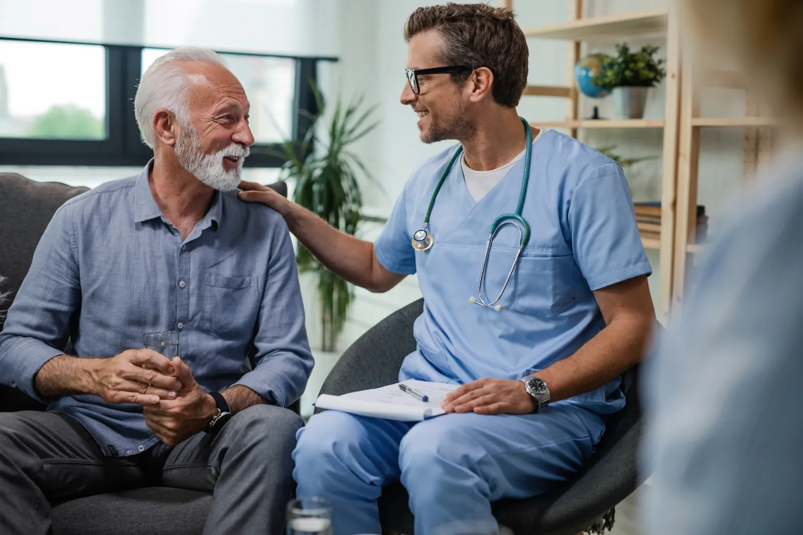 Doctor talking about men's health to a smiling patient