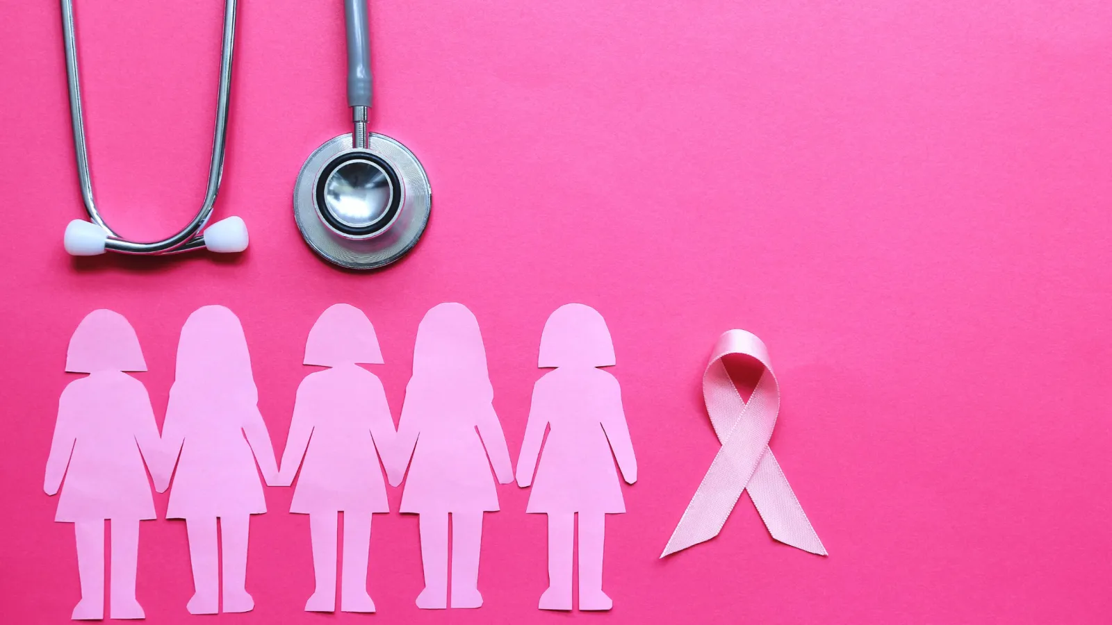 Paper dolls of women and a stethoscope next to a pink ribbon with a pink background