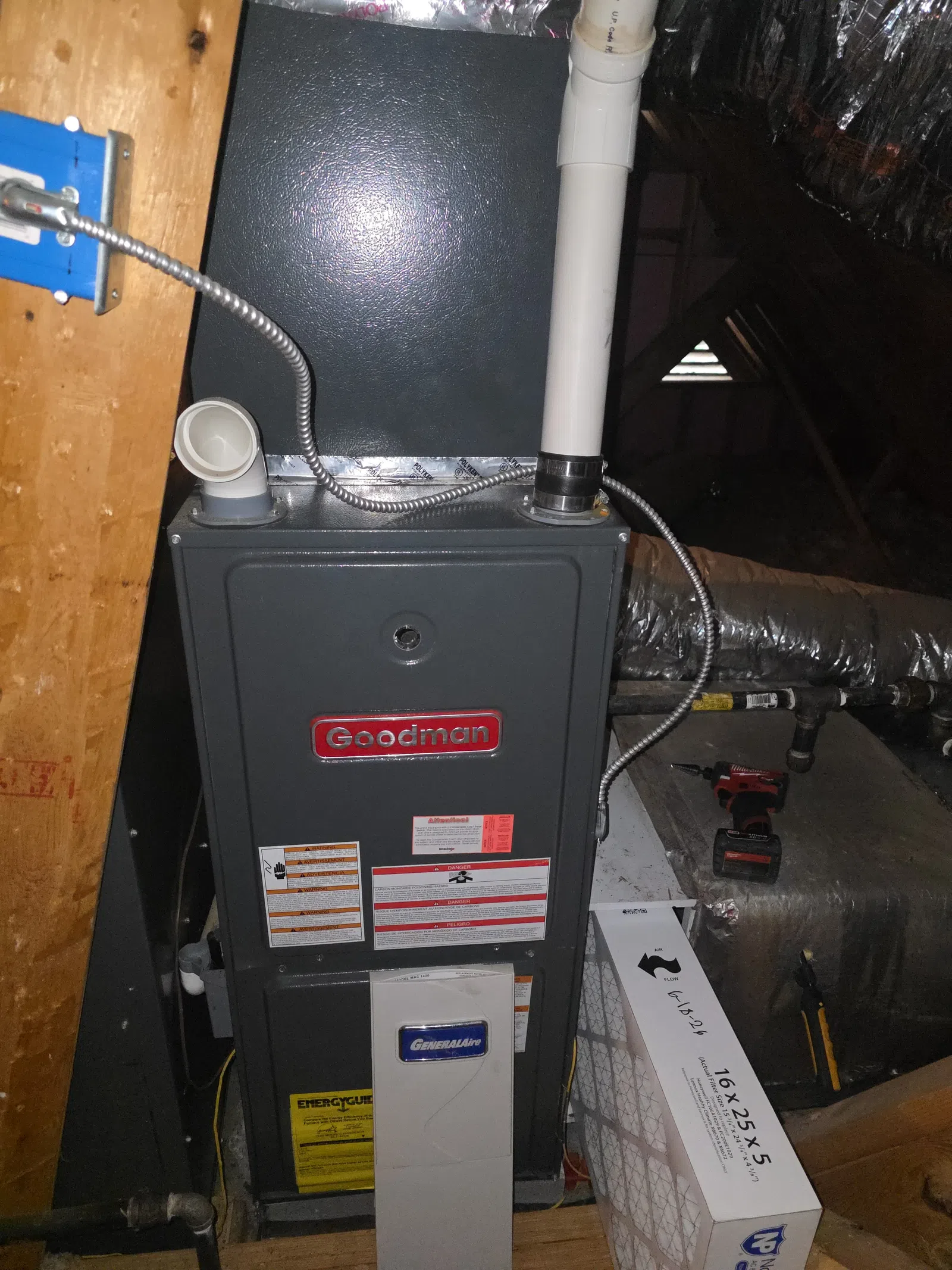 AC Maintenance, Cleaning and Tune-up in Johns Creek by The Air Company of GA. Goodman furnace and GeneralAire air purifier installed in attic with ductwork and air filter nearby.