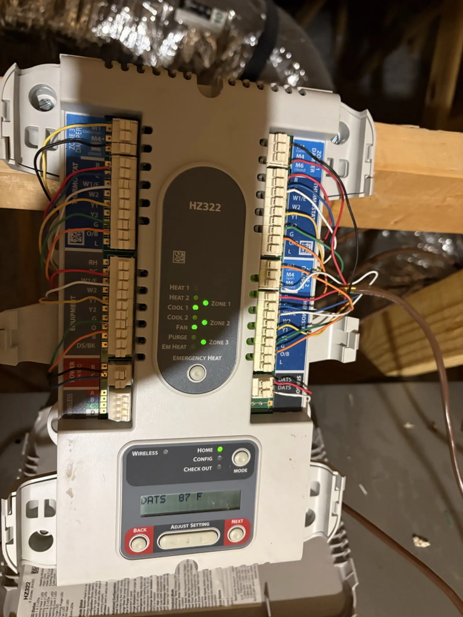HZ322 HVAC control board showing wired connections and status LEDs in an attic space.