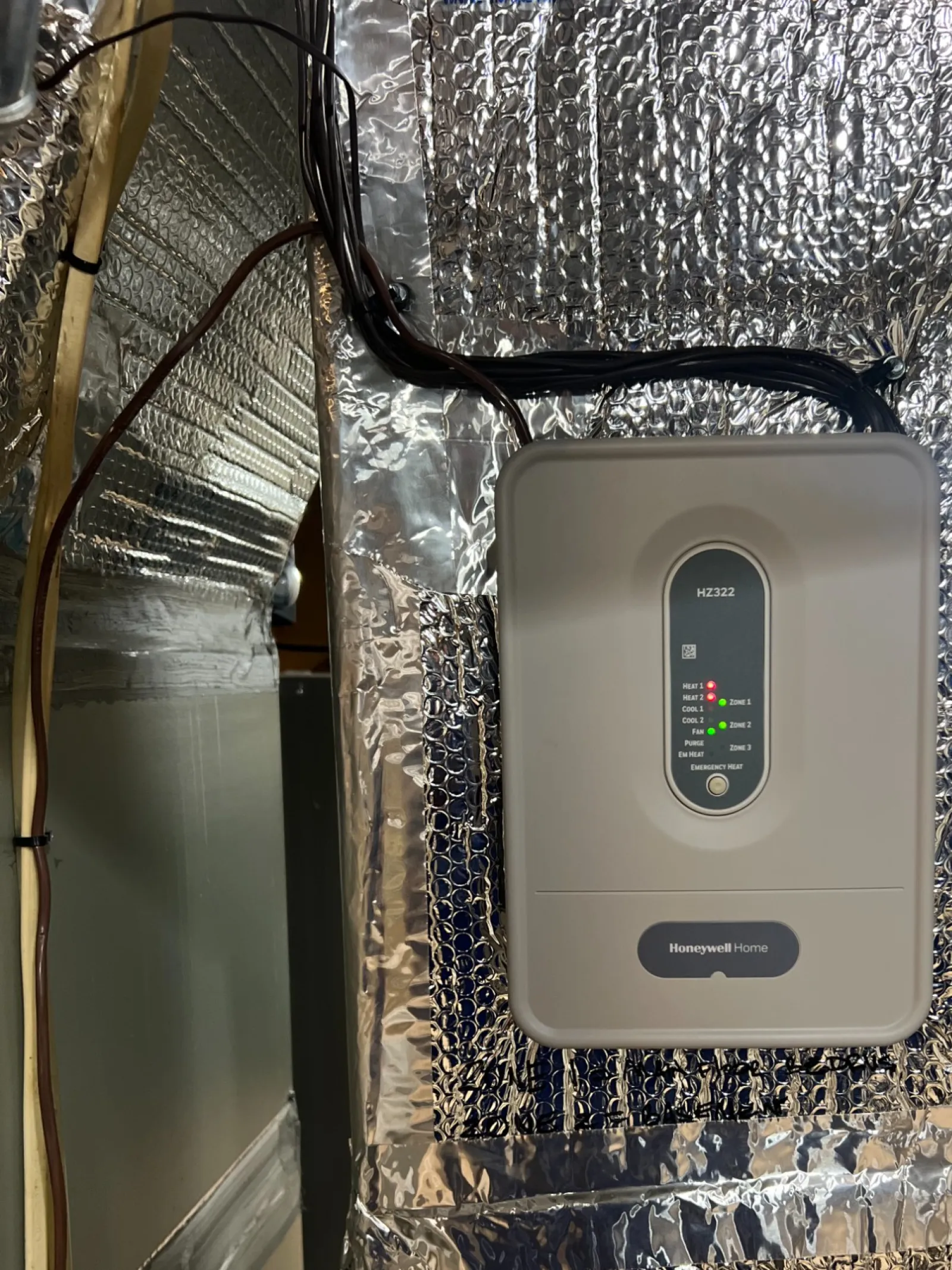 AC Repair in Roswell GA by The Air Company of GA. Honeywell Home HZ321 whole-house humidifier control unit mounted on reflective insulation panel.