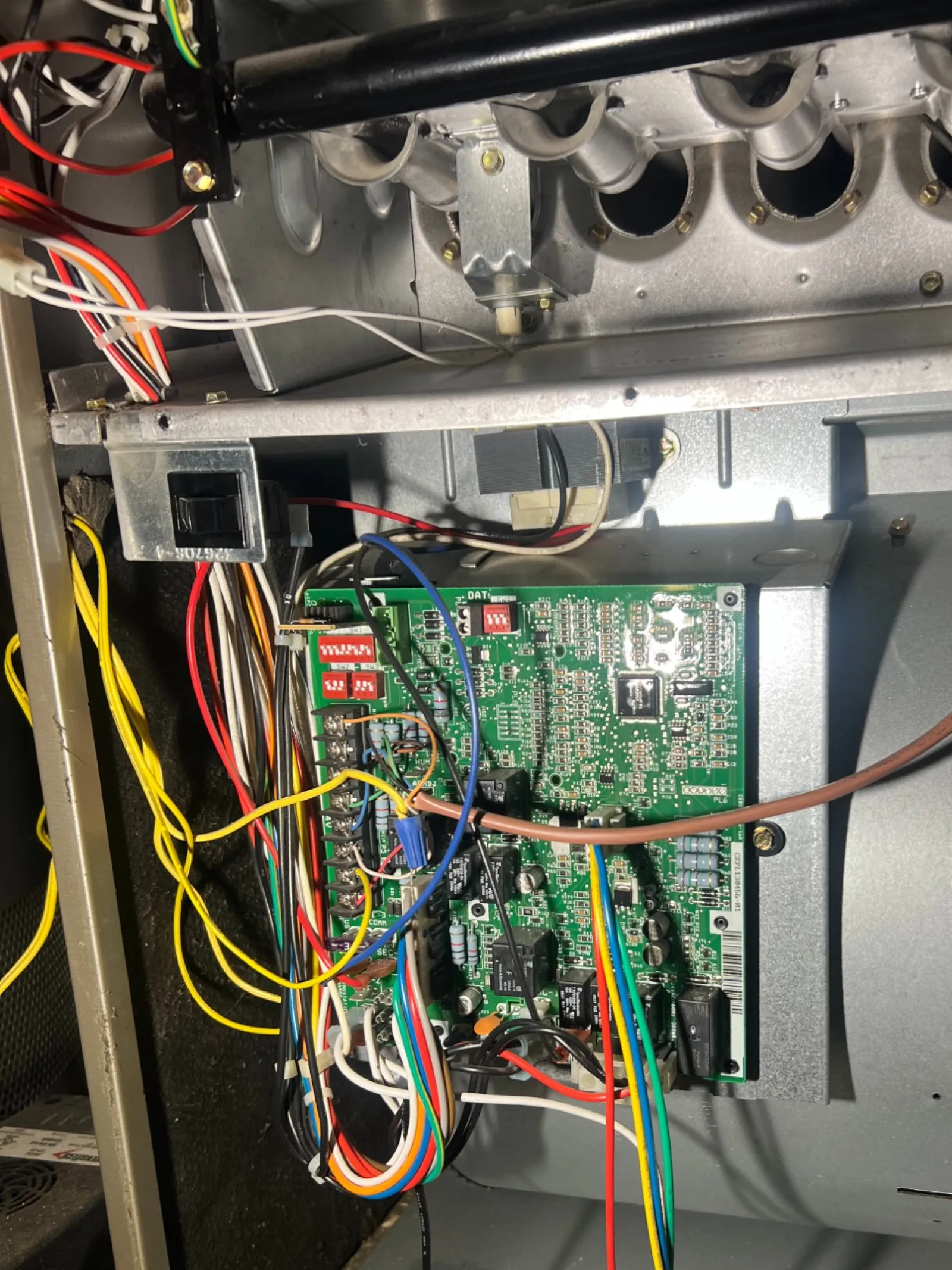 Smyrna AC Cooling Repair in Atlanta 30080 by The Air Company of GA. Internal view of HVAC system showing circuit board, wiring, metal components, and blower fan assembly.