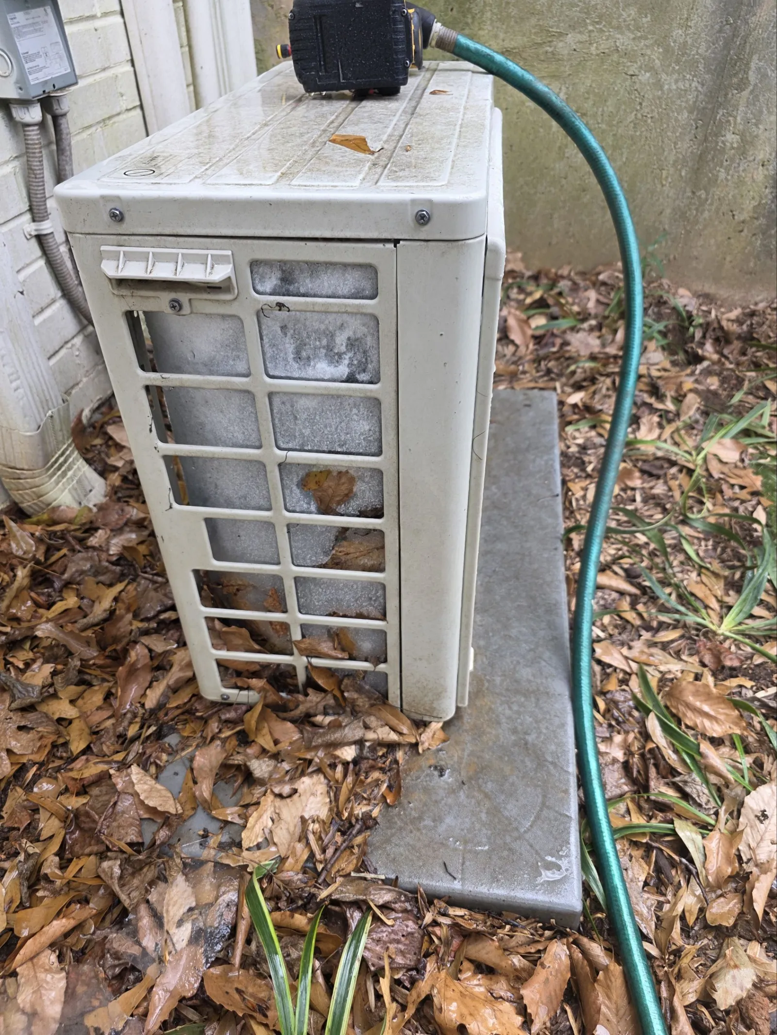 AC Frozen Repair in Atlanta 30327 by The Air Company.  Old air conditioning unit outdoors with moldy vents